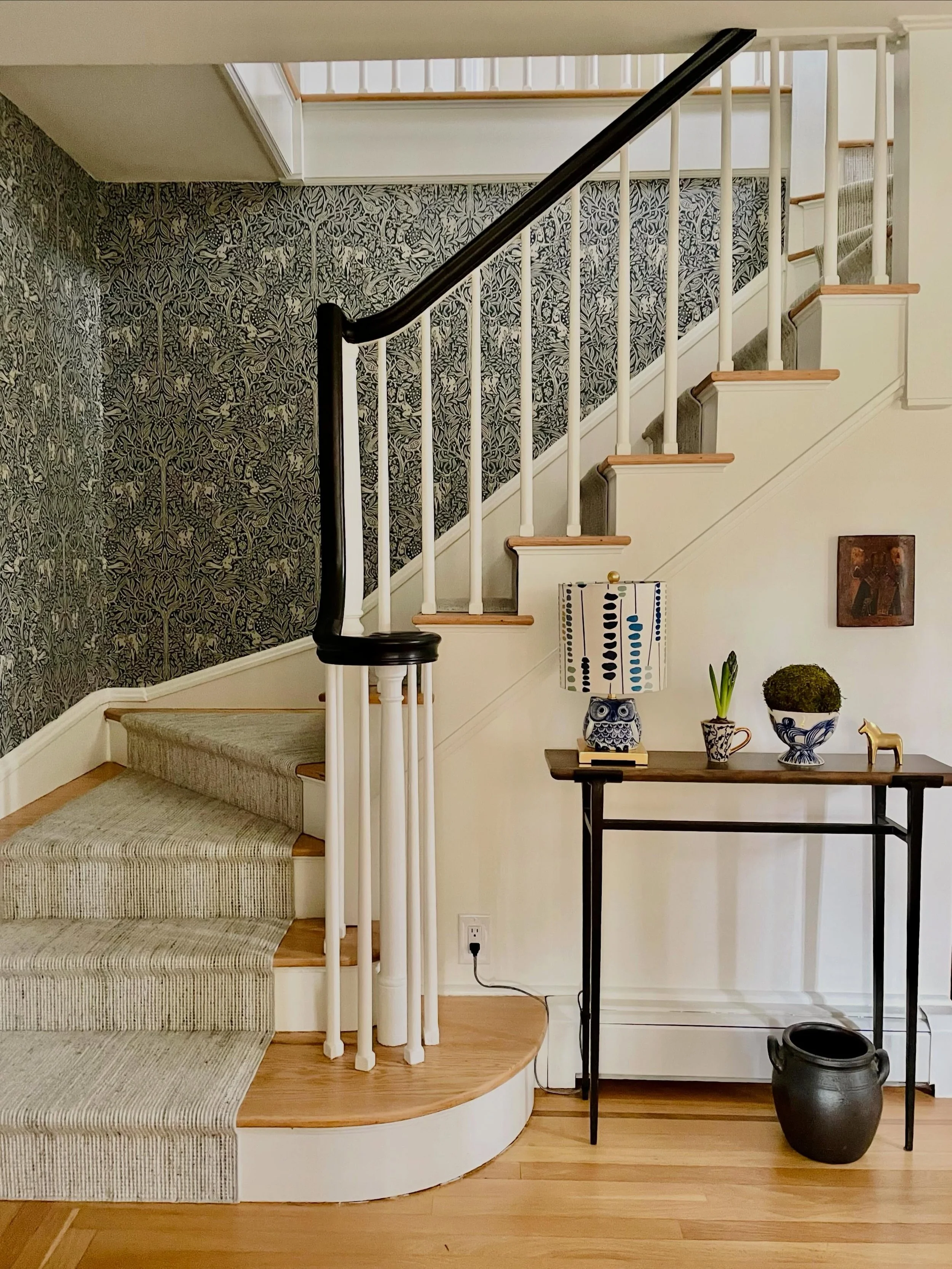 Welcome! 

A previously very dark entry foyer (see the last picture)  was recently transformed with new paint, sanded floors, stair runner, wallpaper and Swedish influences. 
The wallpaper, &ldquo;Under The Elder Tree&rdquo;, by @borastapeter, depict