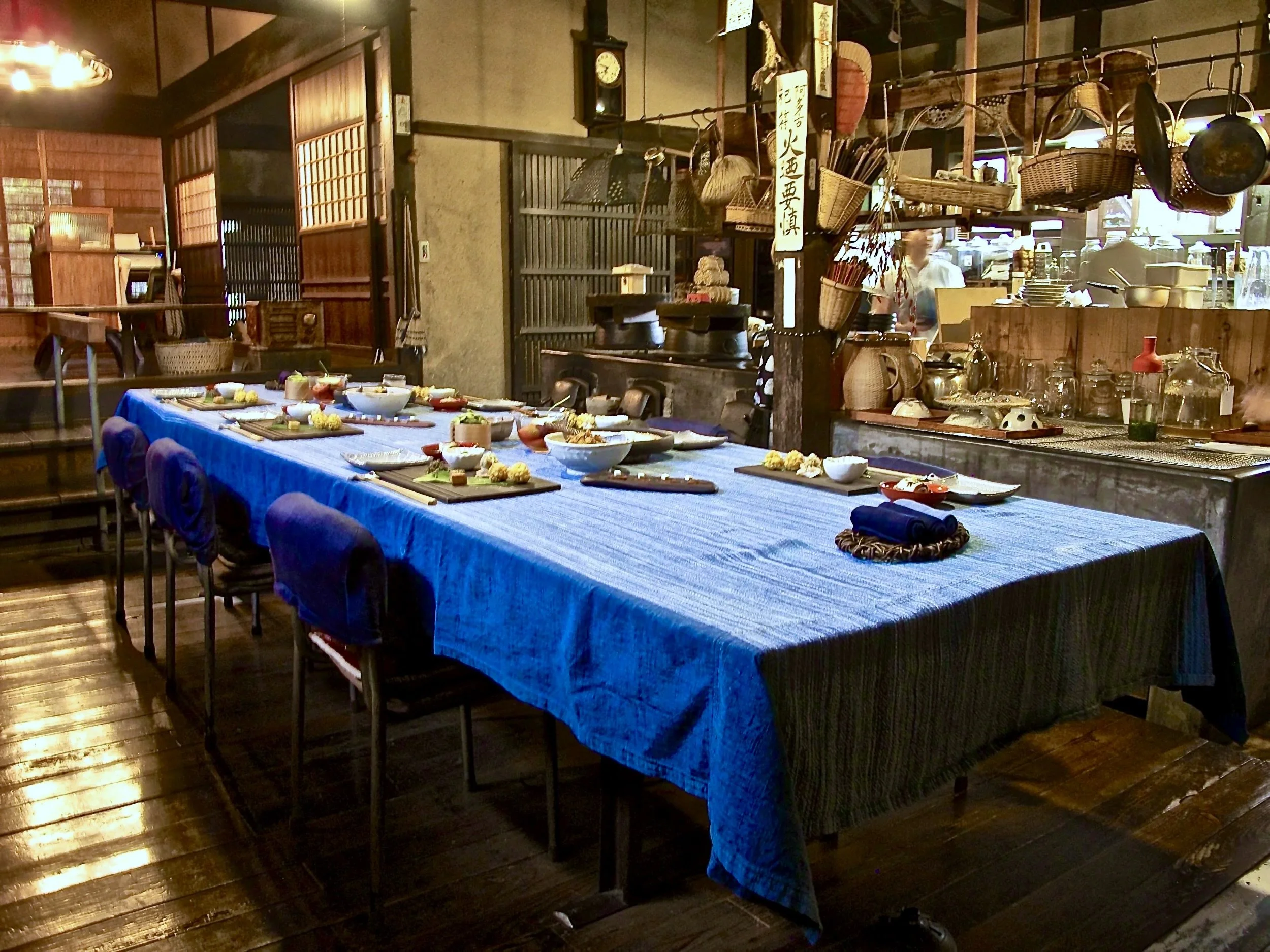 Traditional kitchen at Takyo Abeke with kamado stove and table set for a meal