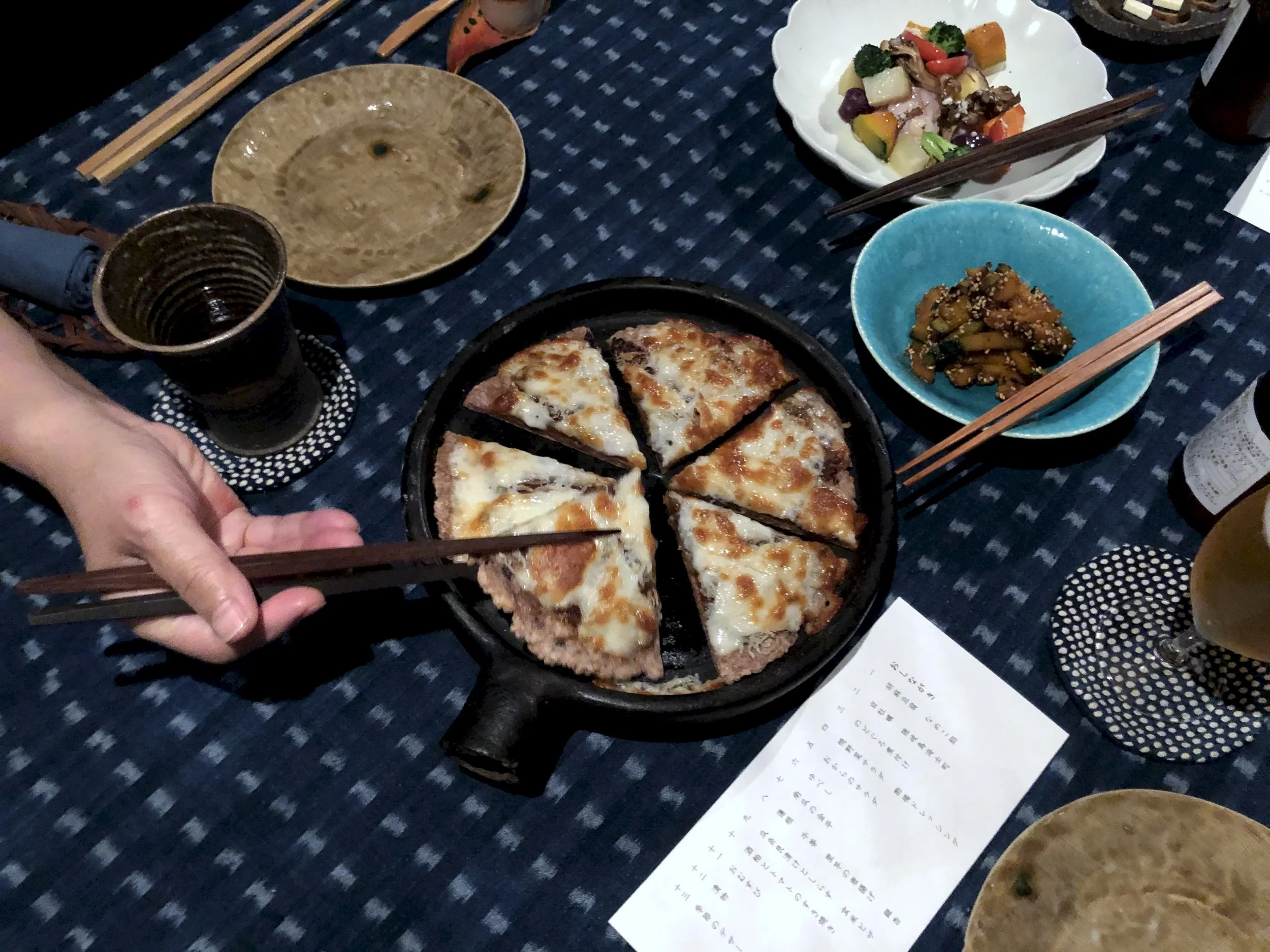 Guests sharing seasonal dishes with chopsticks at Takyo Abeke dinner table