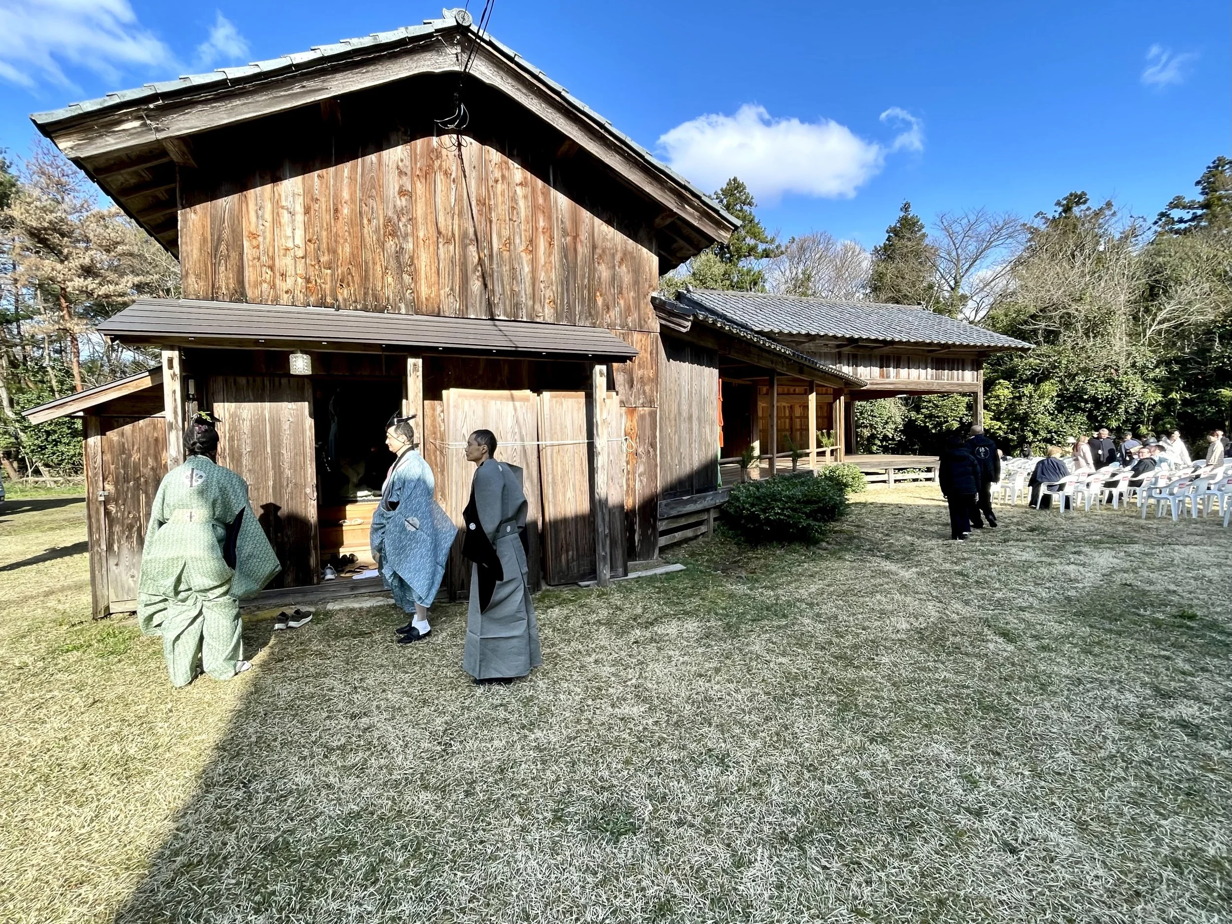 Noh performers and guests gathered around the stage at Kamo Shrine on Sado Island before a full day of performances