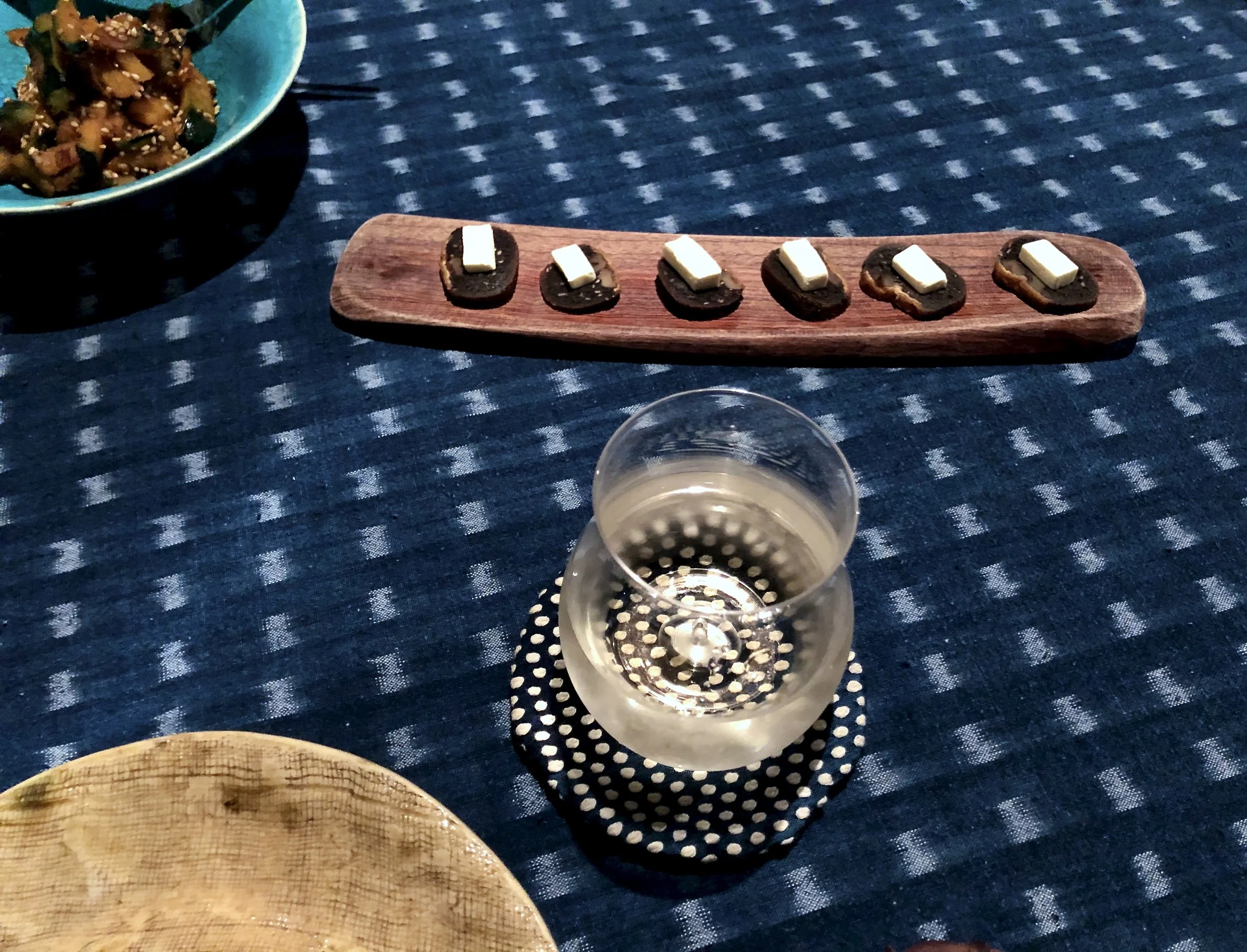 Slices of yubeishi topped with cream cheese, served on a tray at the dinner table at Takyo Abeke