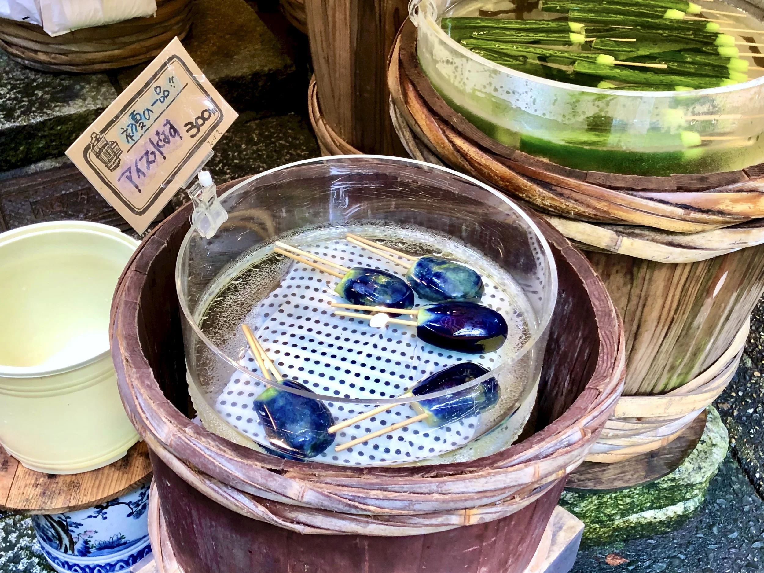 Iced tsukemono—small eggplants and cucumbers on sticks—kept cool in barrels along the path to Sanzen-in in Ohara