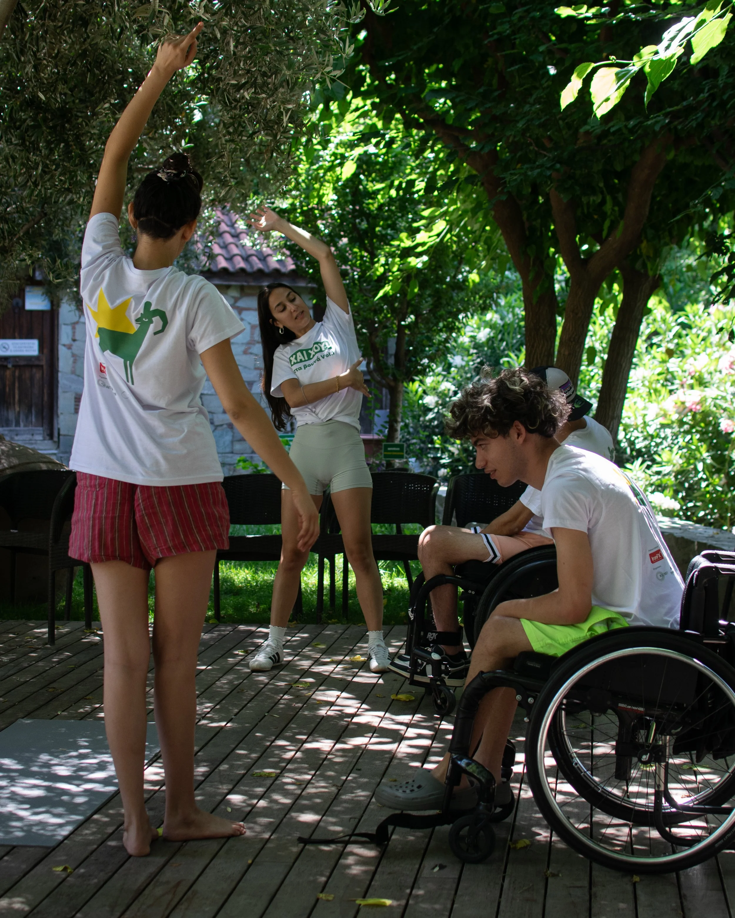 An outdoor yoga therapy session where Angelica the therapist is helping disabled individuals with regulating their nervous system.