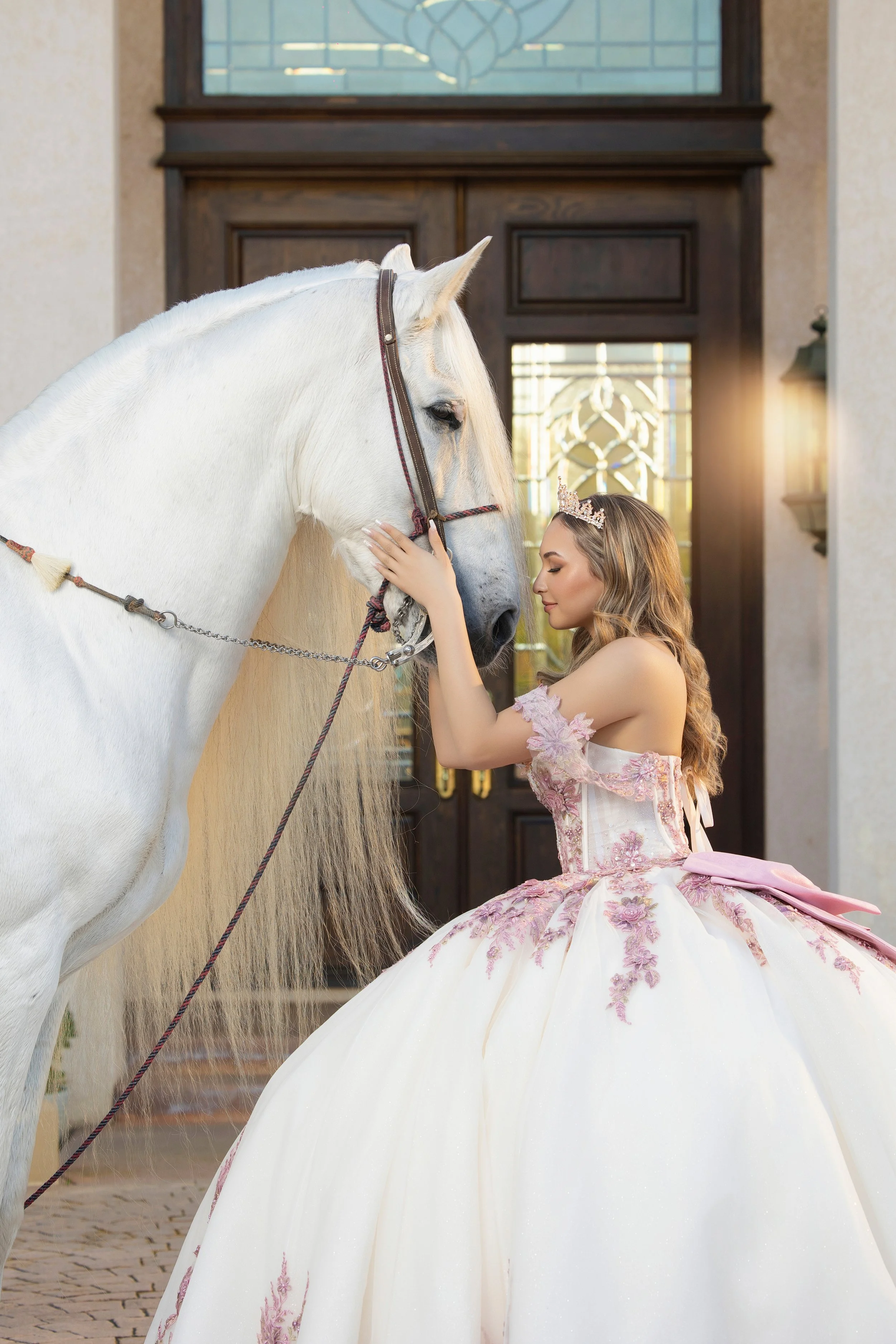 Quinceañera in a Moda 2000 pink dress and a tiara with a white horse at Rancho Jalisco in Redlands, Riverside, and Inland Empire.