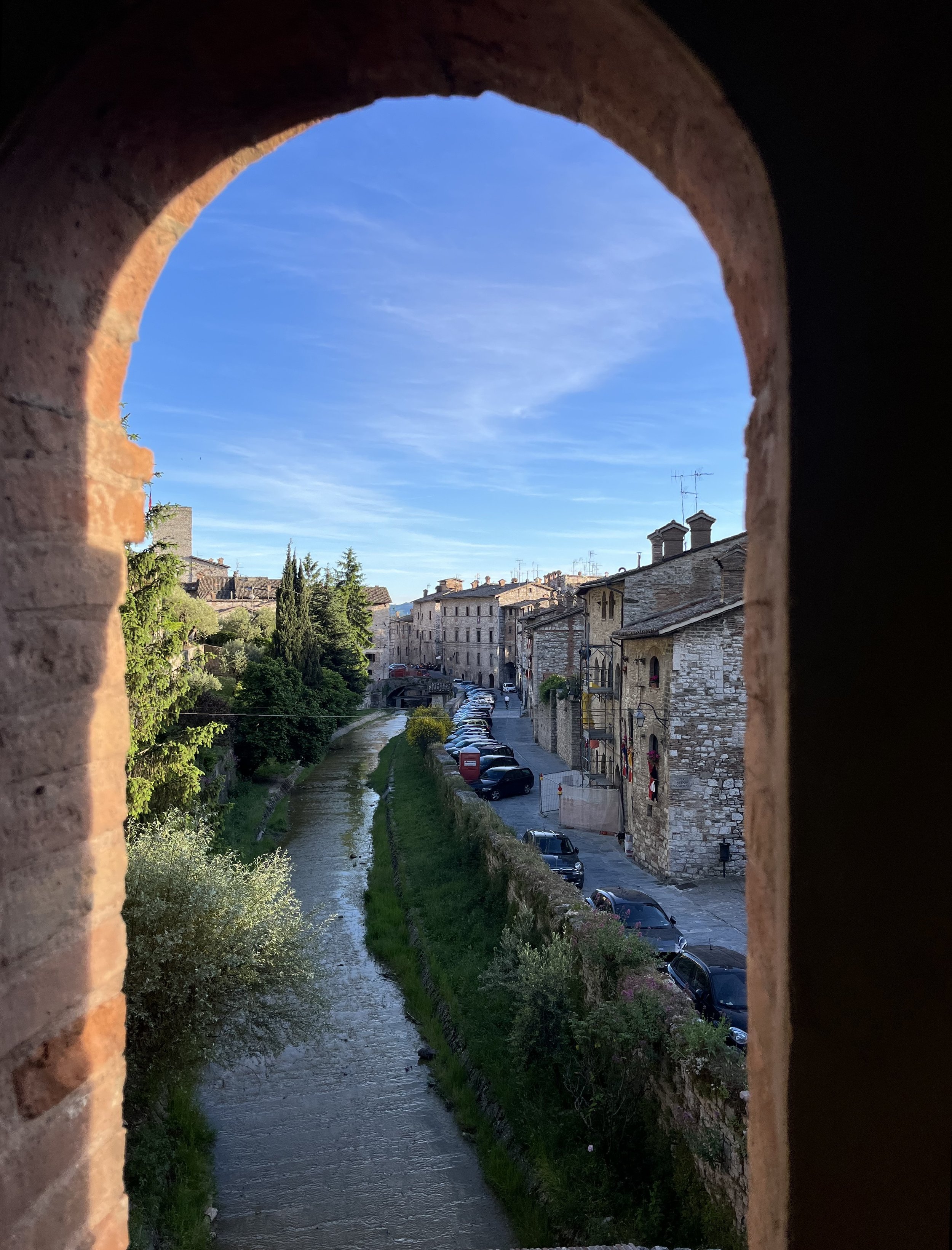 View of street through arch in Gubbio, Italy