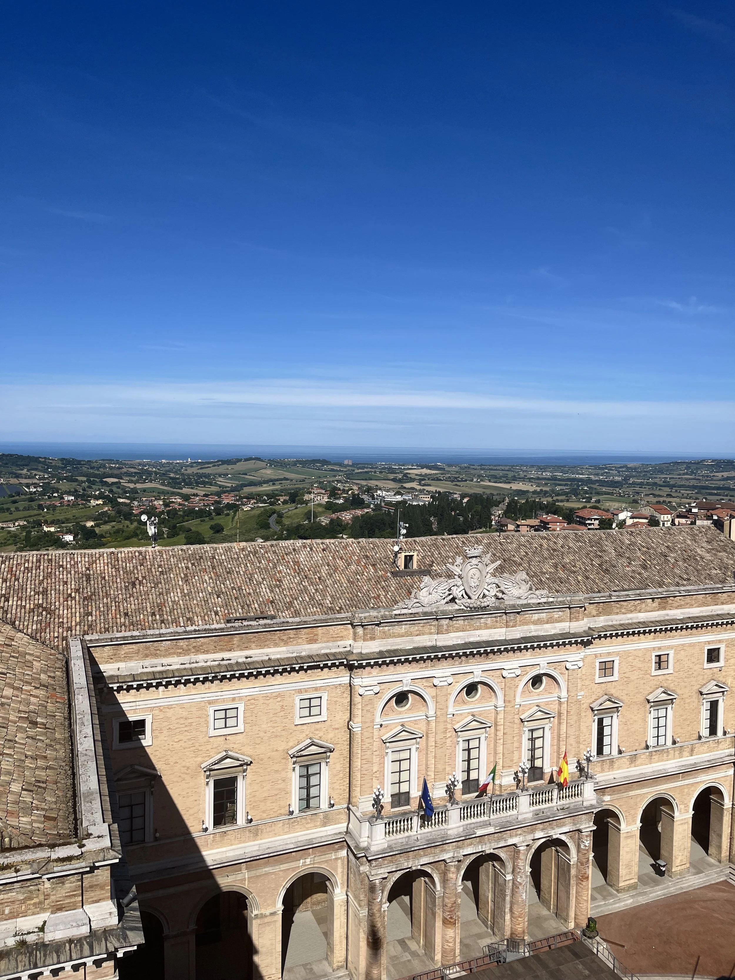 View of Le Marche countryside and sea from tower in piazza in Recanati, Italy