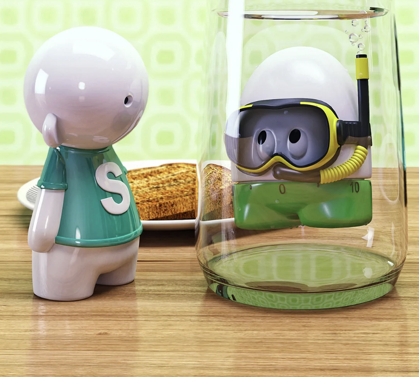 A toy figure with a large round head and teal shirt next to a glass container with a small character wearing snorkeling gear and a diving helmet, with toast in the background on a wooden surface.