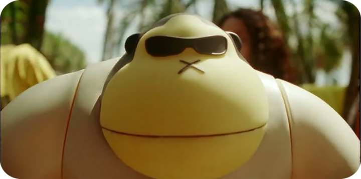 A cartoon character with a rounded yellow face, wearing black sunglasses, and a large white body.
