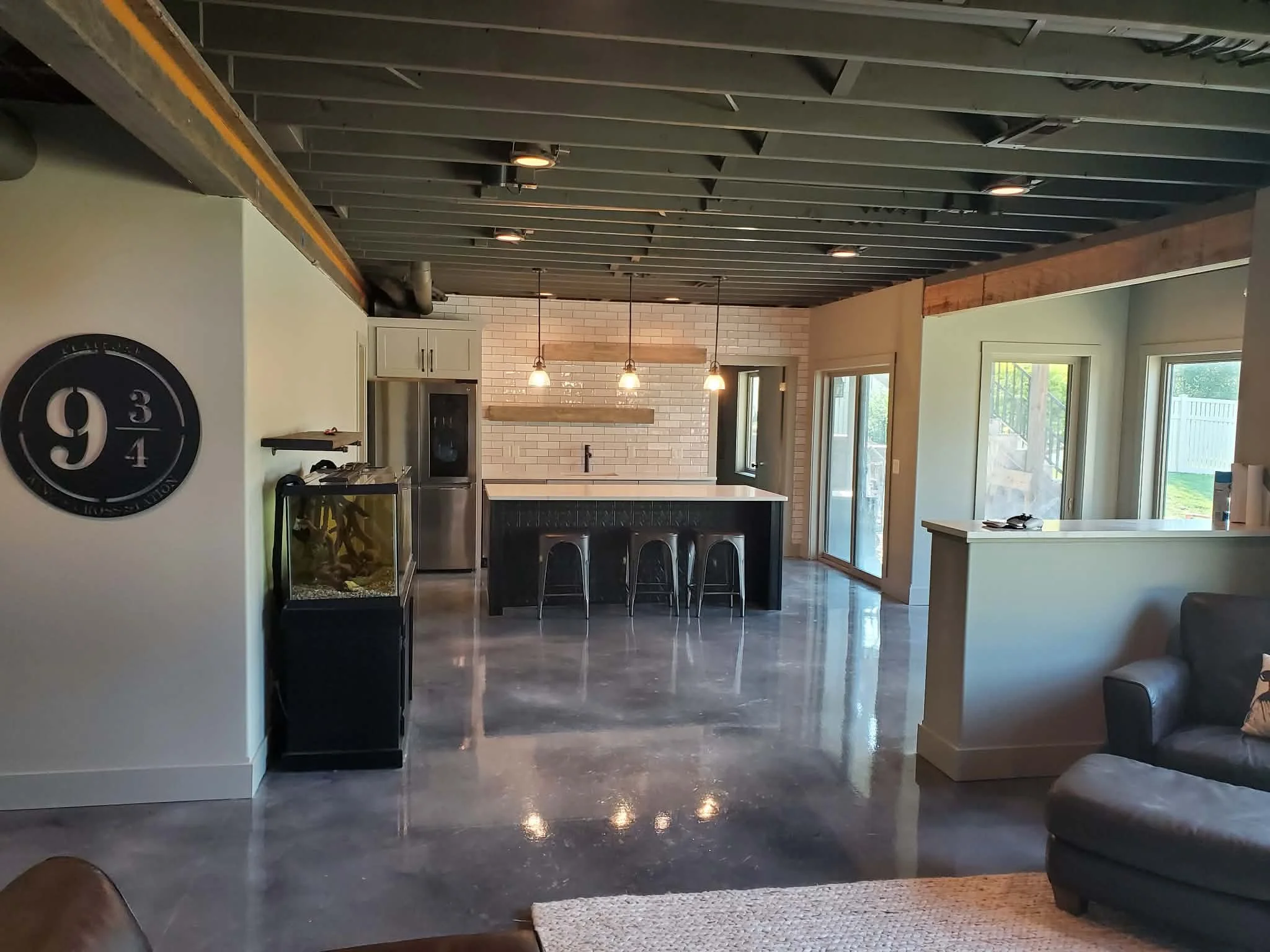 Finished basement with living and bar area.