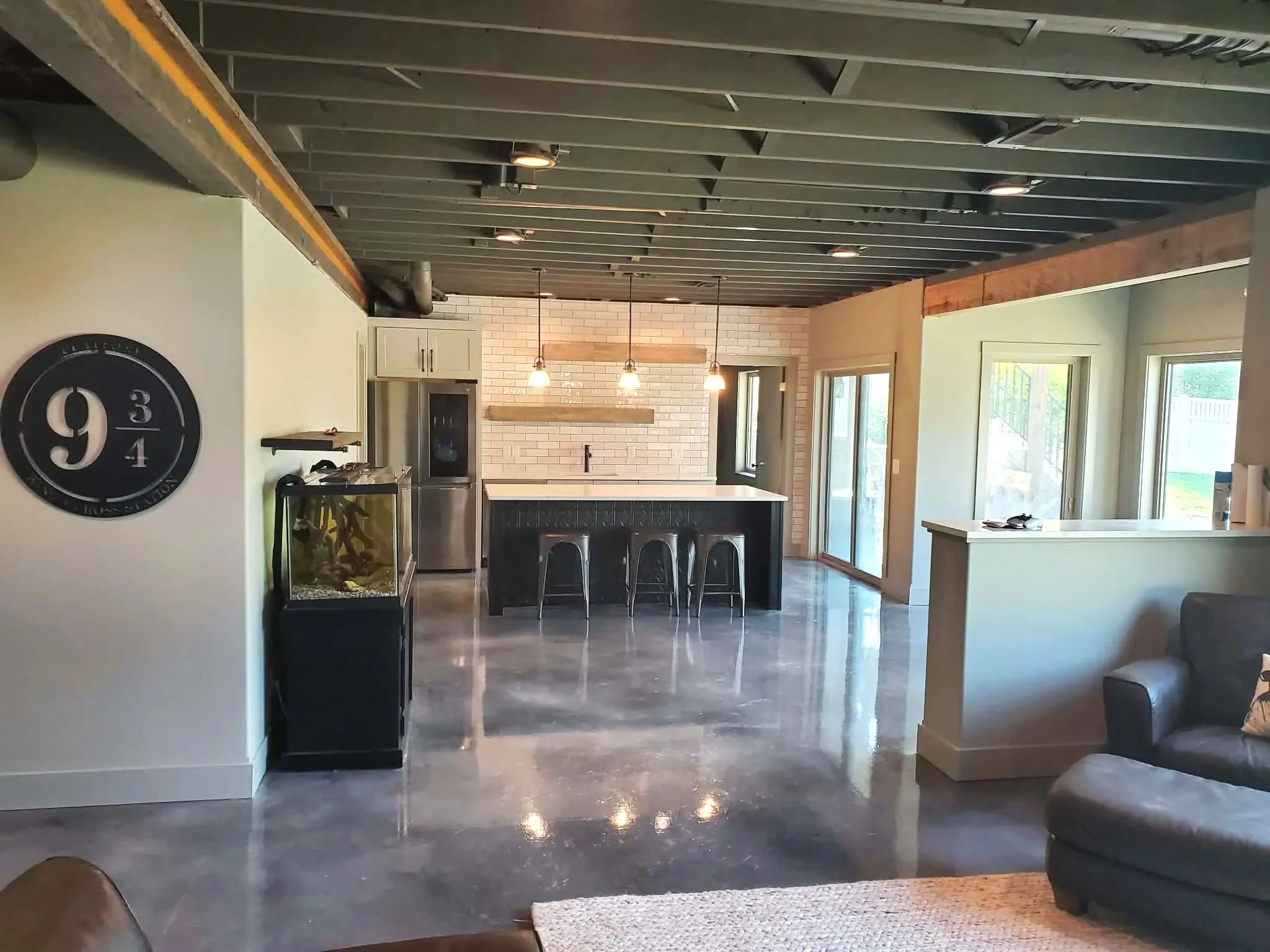Finished basement with living and bar area.
