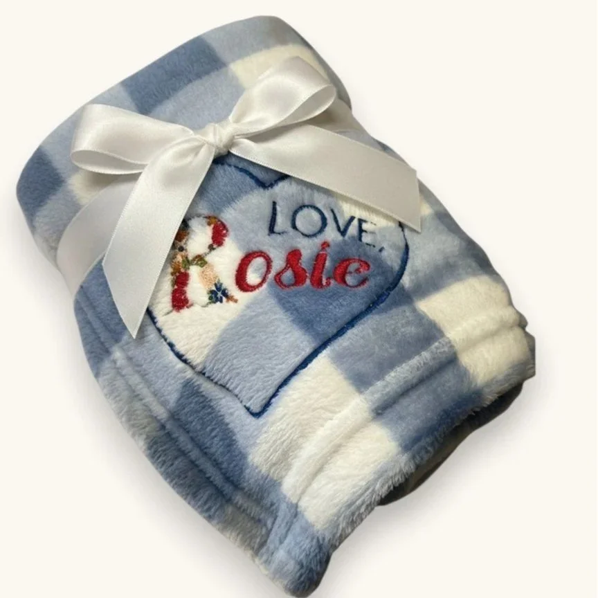 Blue gingham blanket with blue heart embroidered, words Love, Rosie embroidered, the letter R is made up of roses and differing colors 