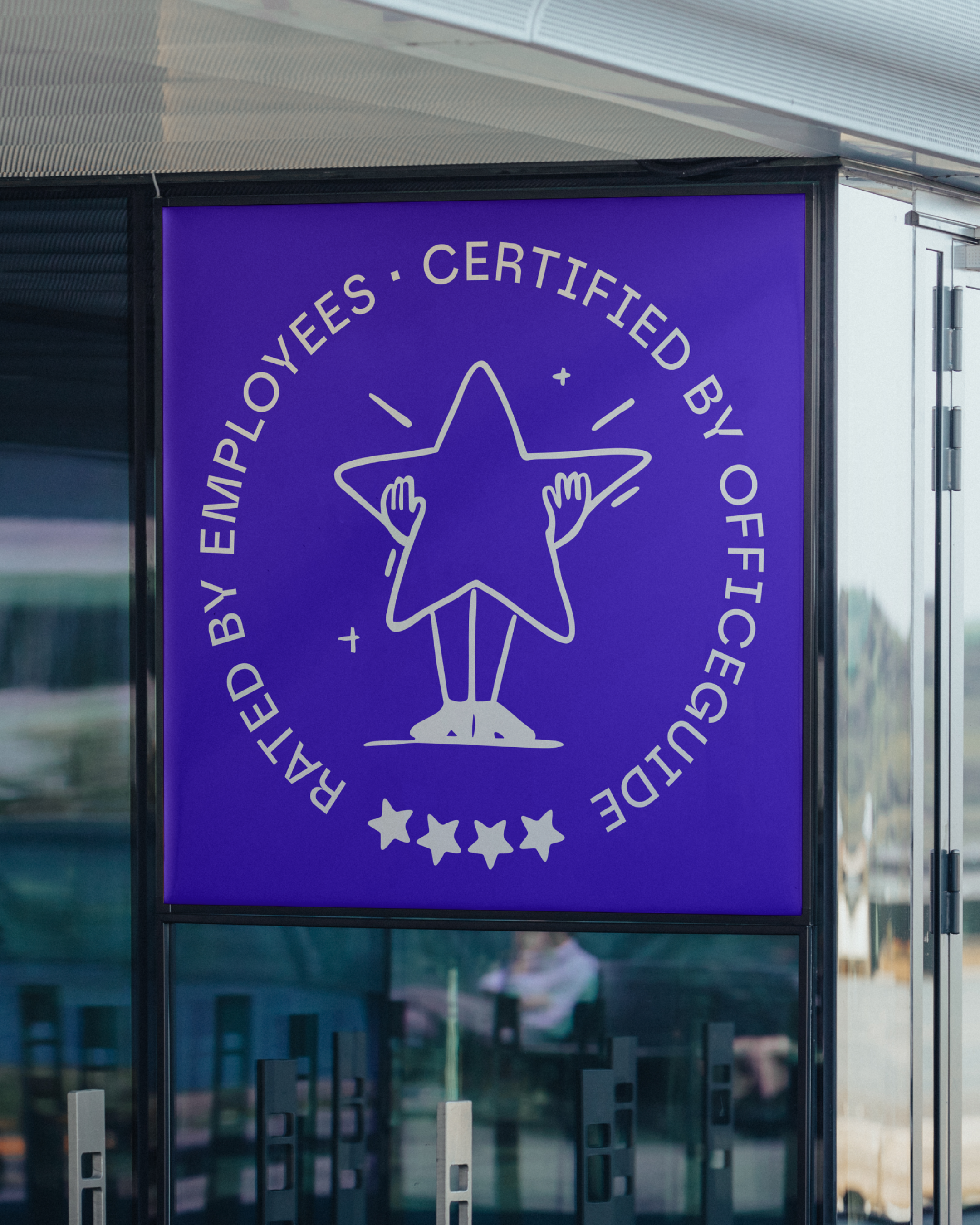 Sign with a blue background and white graphic and text. The graphic is a star with two hands holding it. The text around the star reads: "Regulatory Body Certified by You" and has a five-star rating at the bottom.