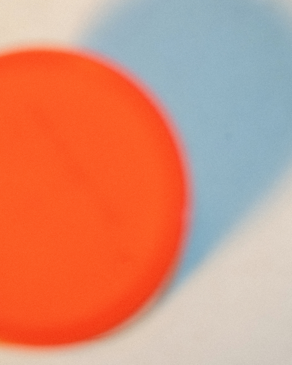 Close-up of an orange circular object with blue and beige background.