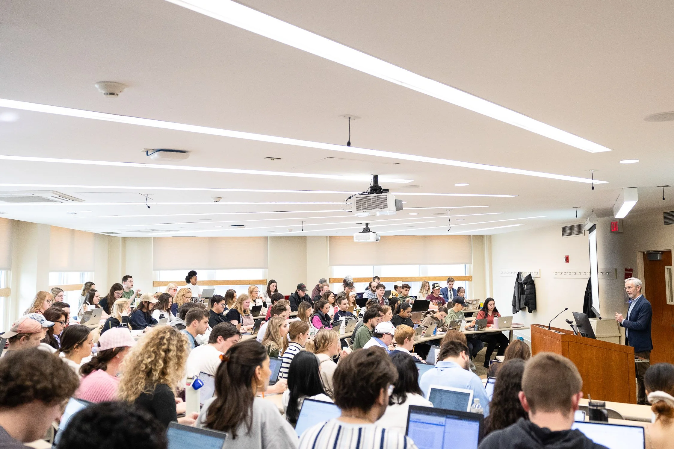 A large lecture filled with students listening to a law professor at New England Law Boston.