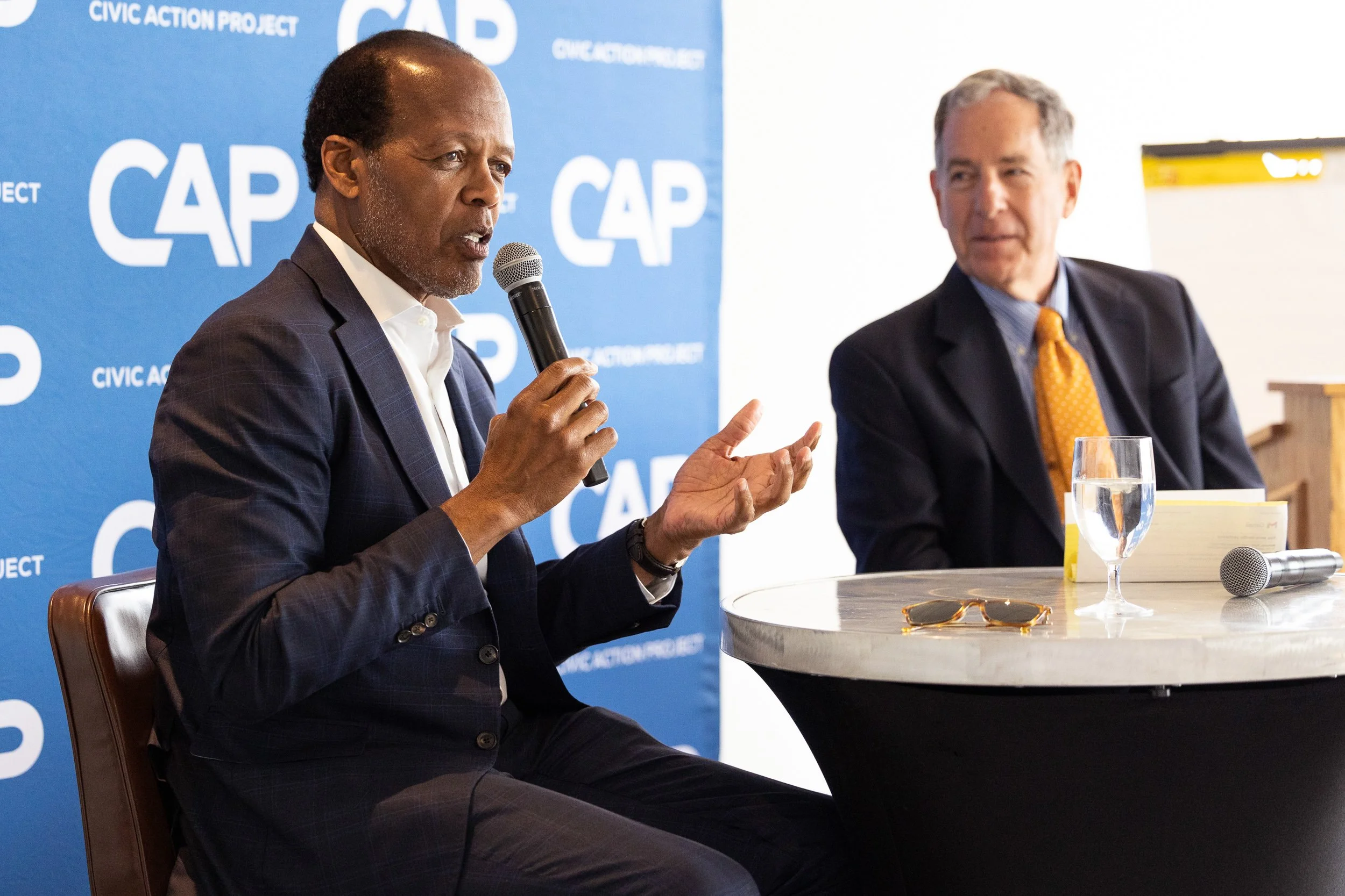 Lee Pelton sitting at a round table during a discussion at the Umass Club in Boston.