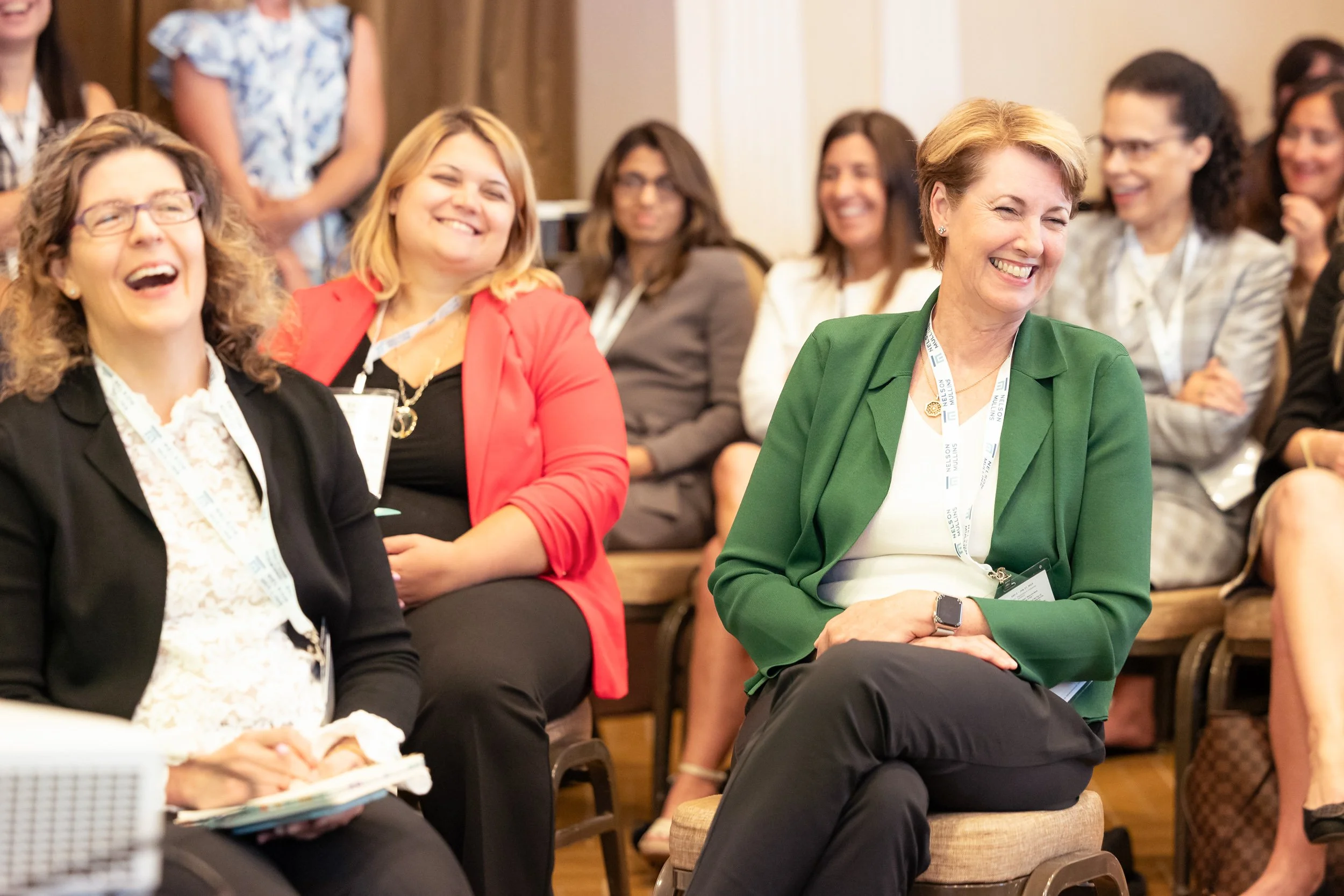 Group of women at a Boston conference sitting and laughing together.