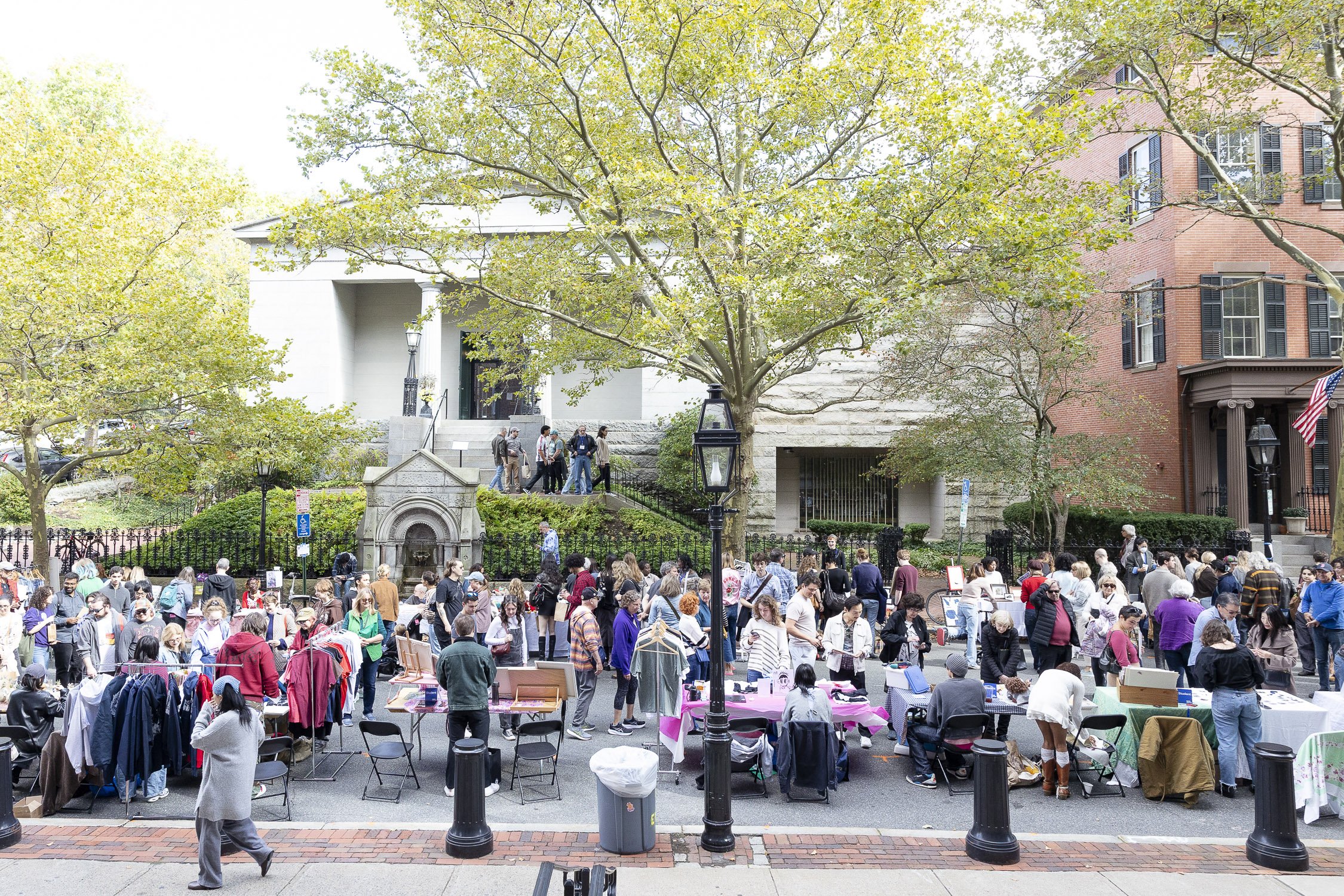 Crowd of people shopping at an outdoor market on a city street at RISD Craft in Providence, Rhode Island.
