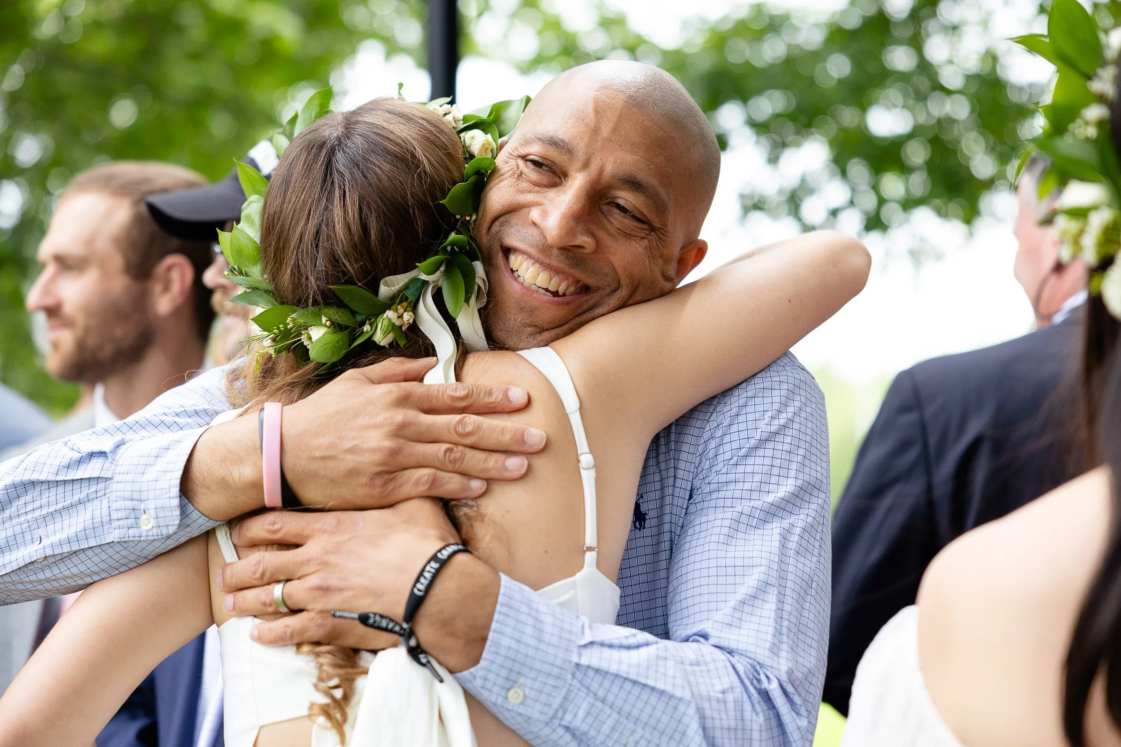 A teacher embracing a high school student who just graduated.
