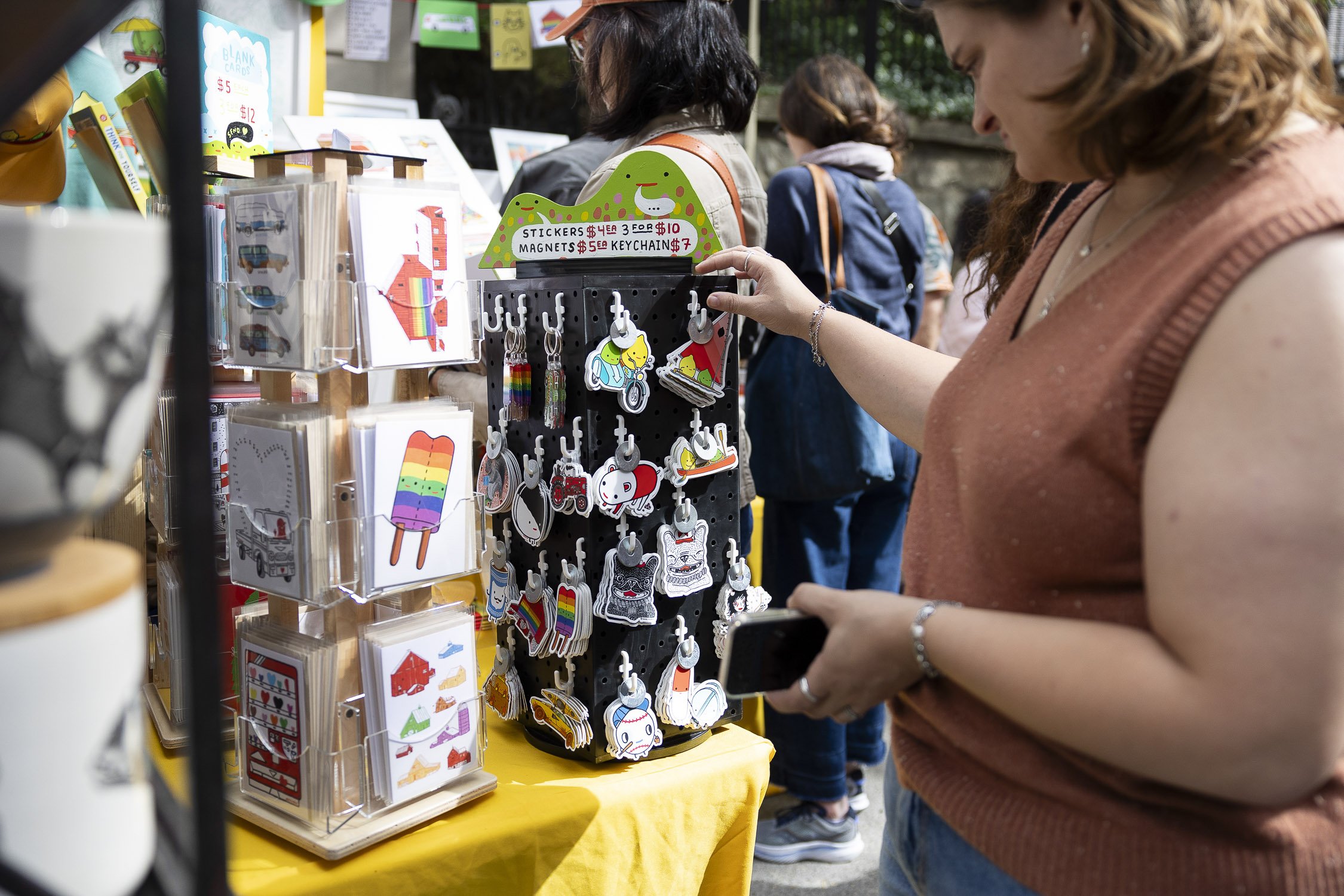 A woman is shopping at an outdoor market at RISD Craft in Providence, Rhode Island.