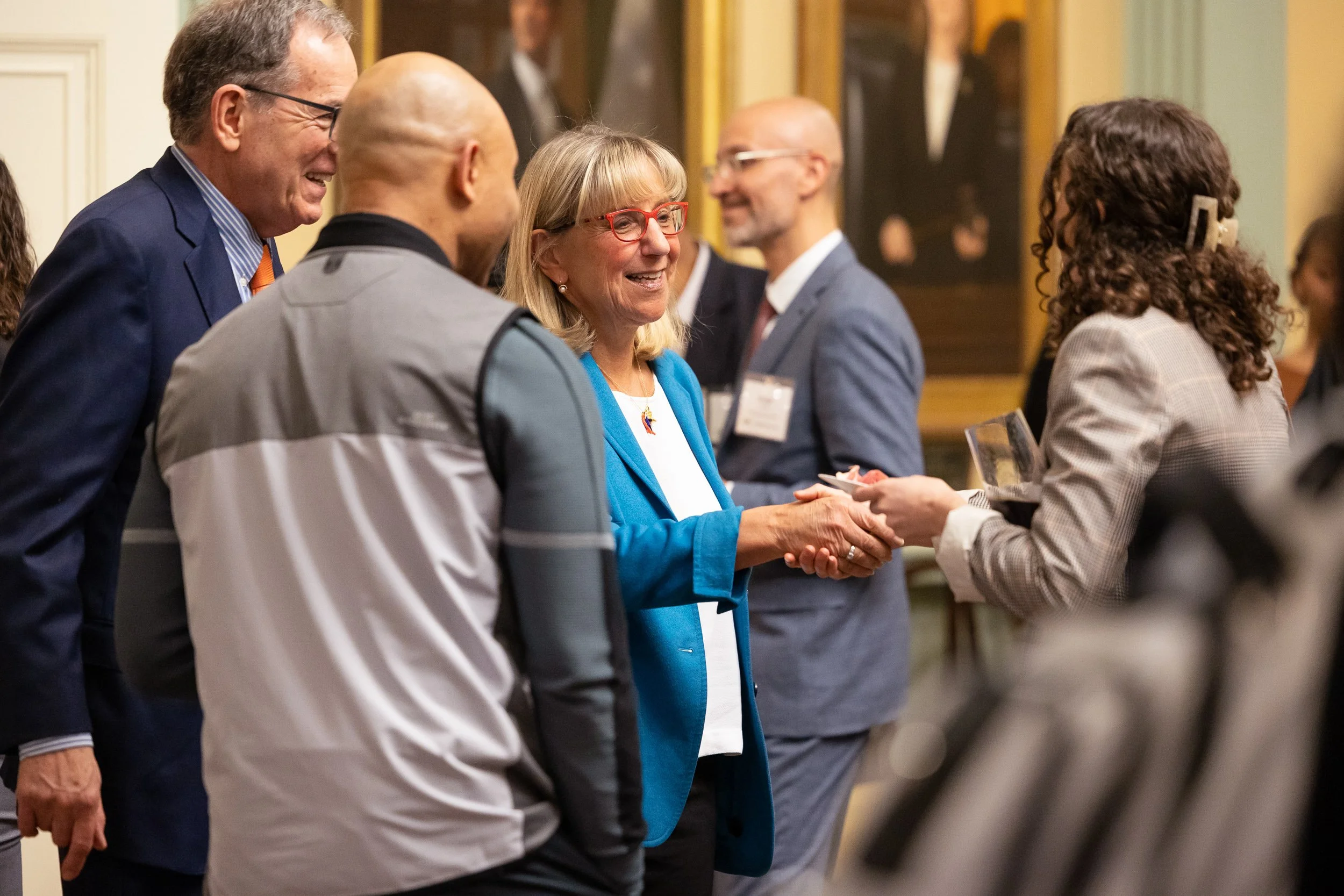 Karen Spilka shaking hands with a guest at an event at the Massachusetts State House in Boston.