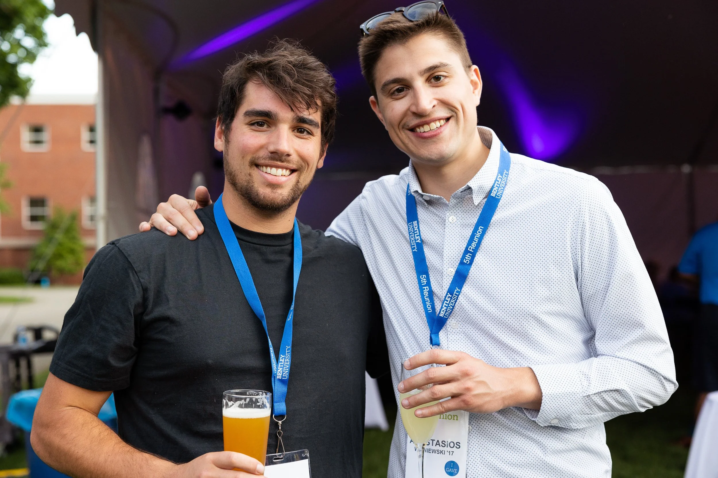 Two young men smiling at the Bentley University reunion.