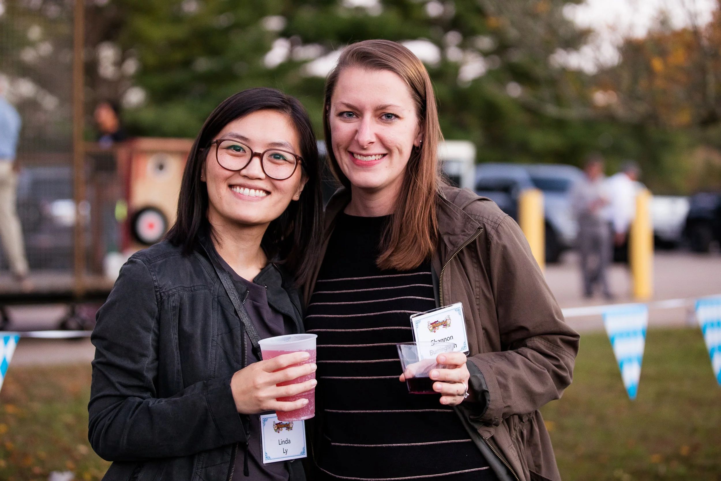 Two women standing outdoors at a company social event in Boston.