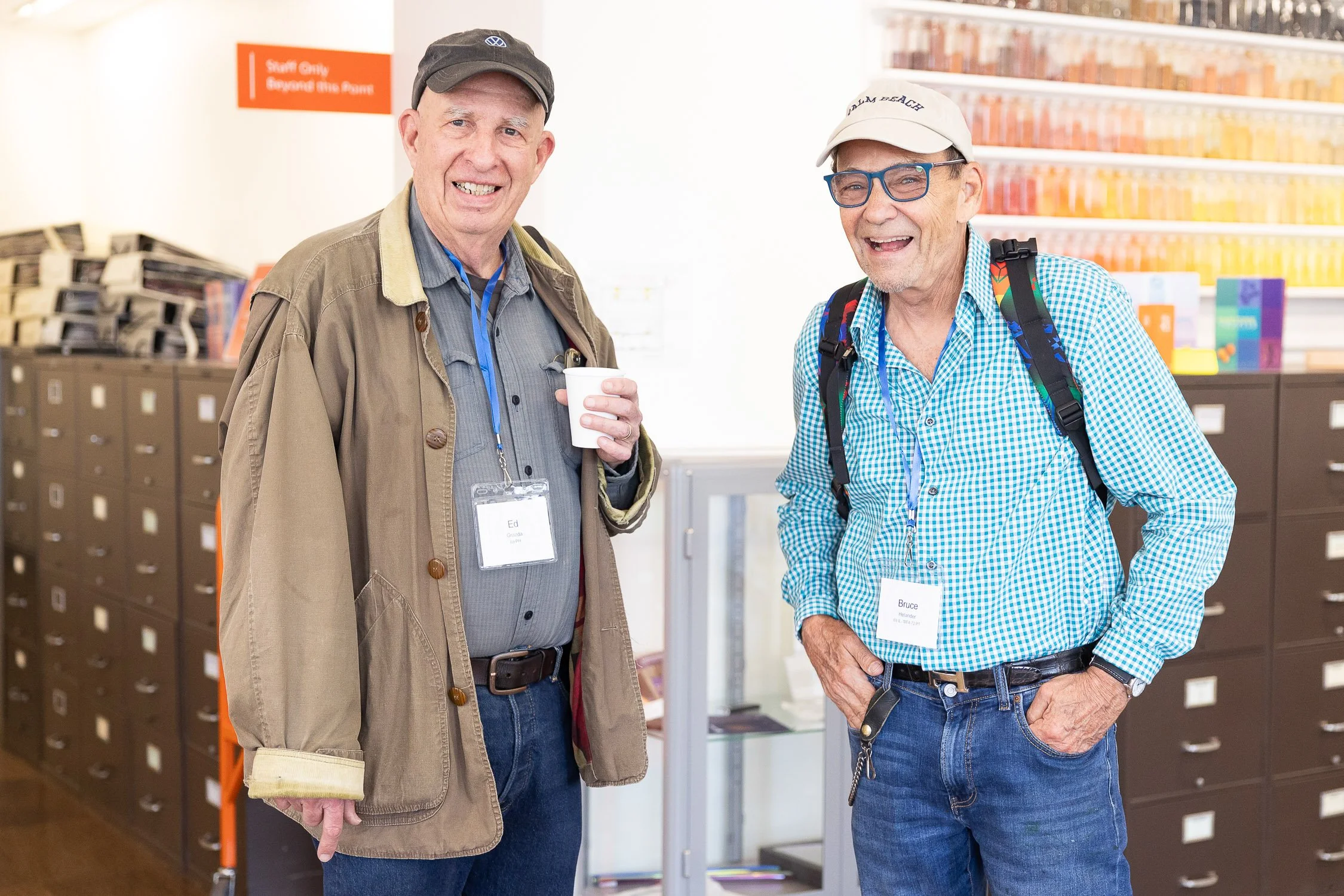 Two men with name tags smiling at RISD reunion.