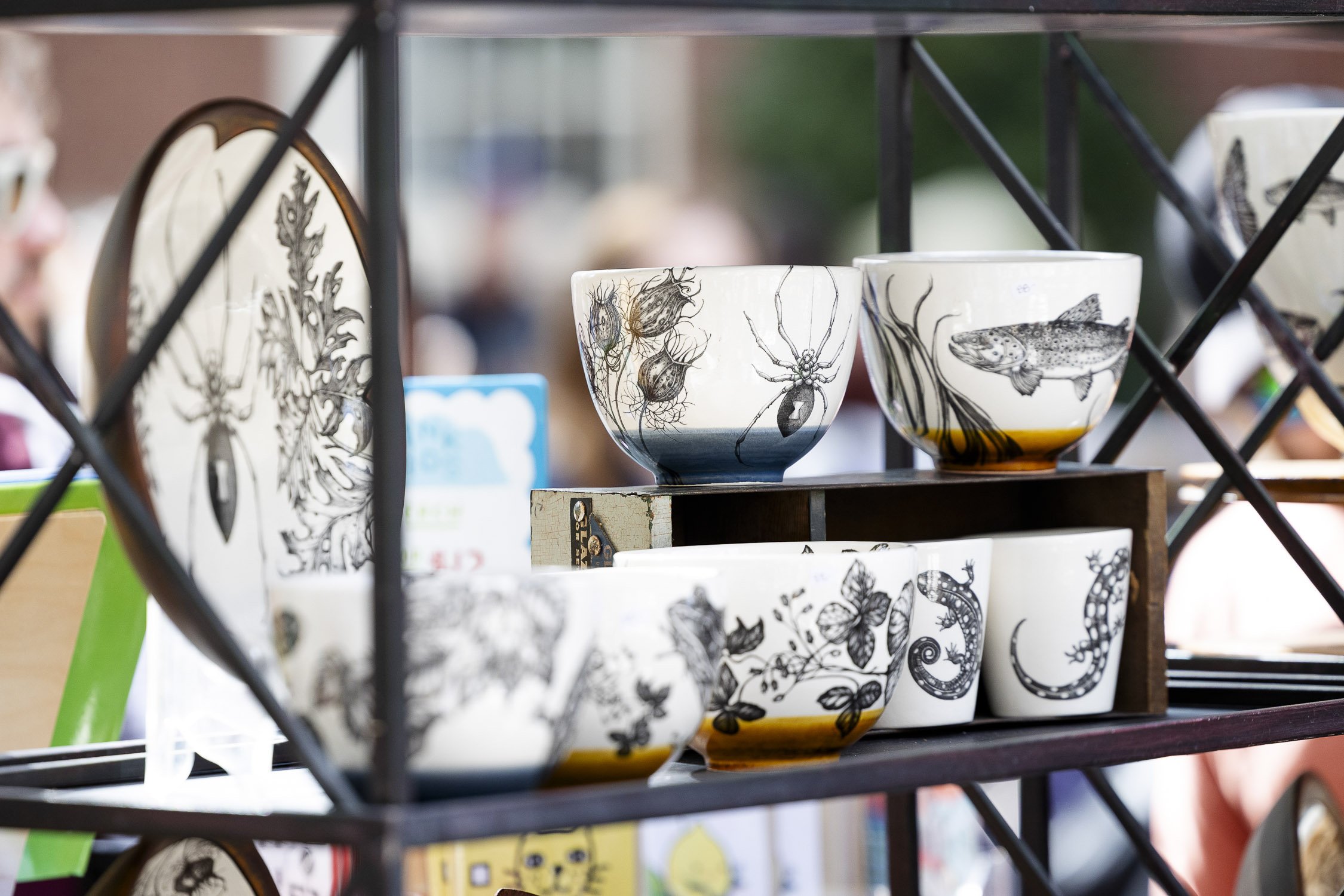Ceramic bowls with black and white insect and animal illustrations at RISD Craft in Providence, Rhode Island.