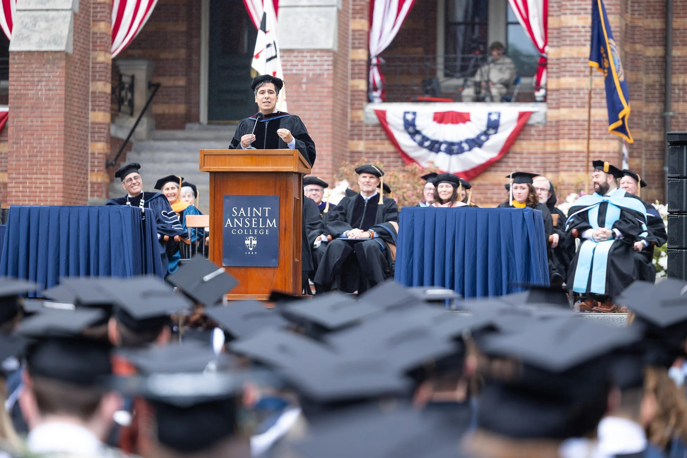 Guest speaker giving a speech at a college graduation ceremony.