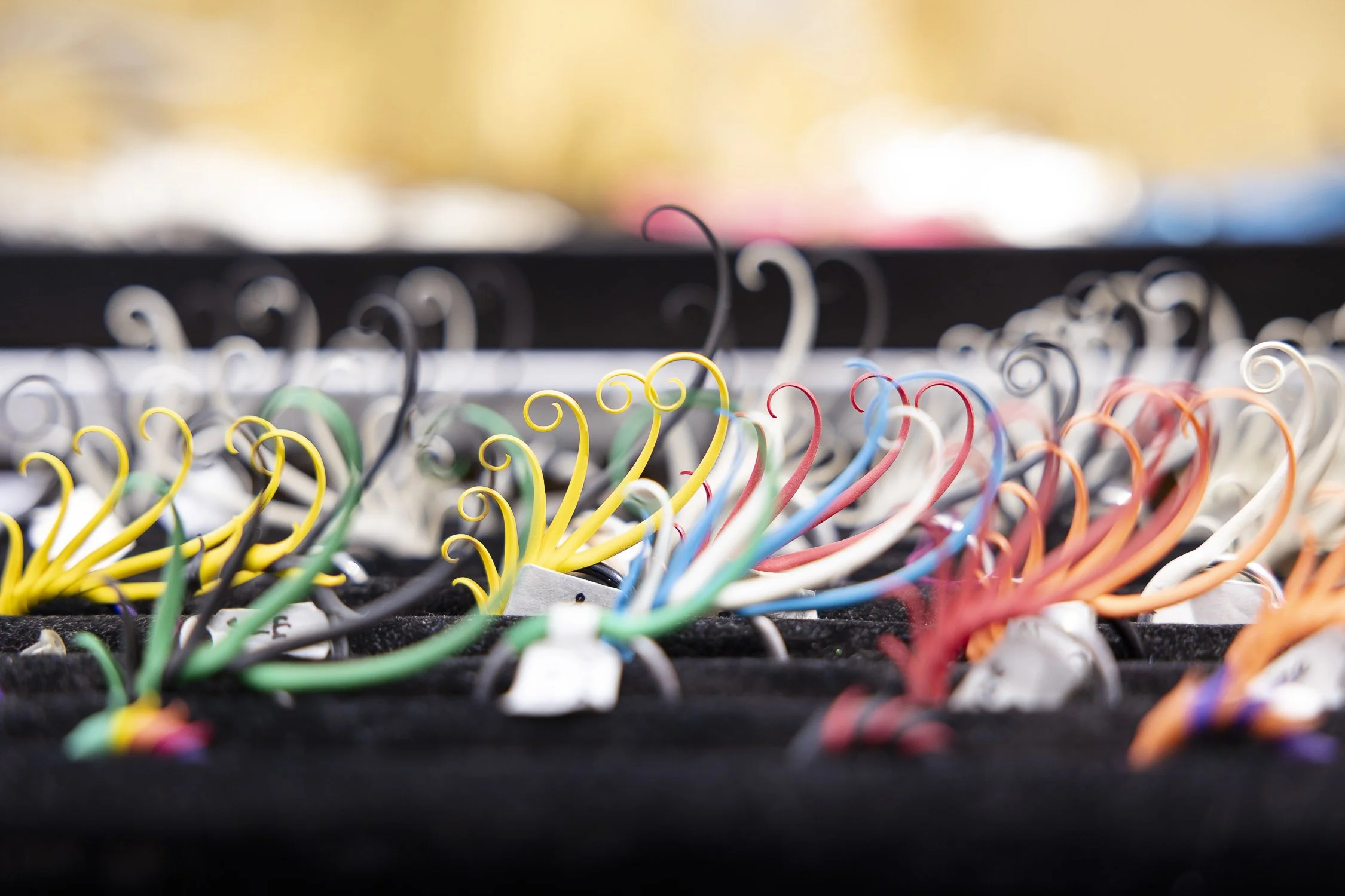 Close-up of colorful curly rings on display at RISD Craft in Providence, Rhode Island.