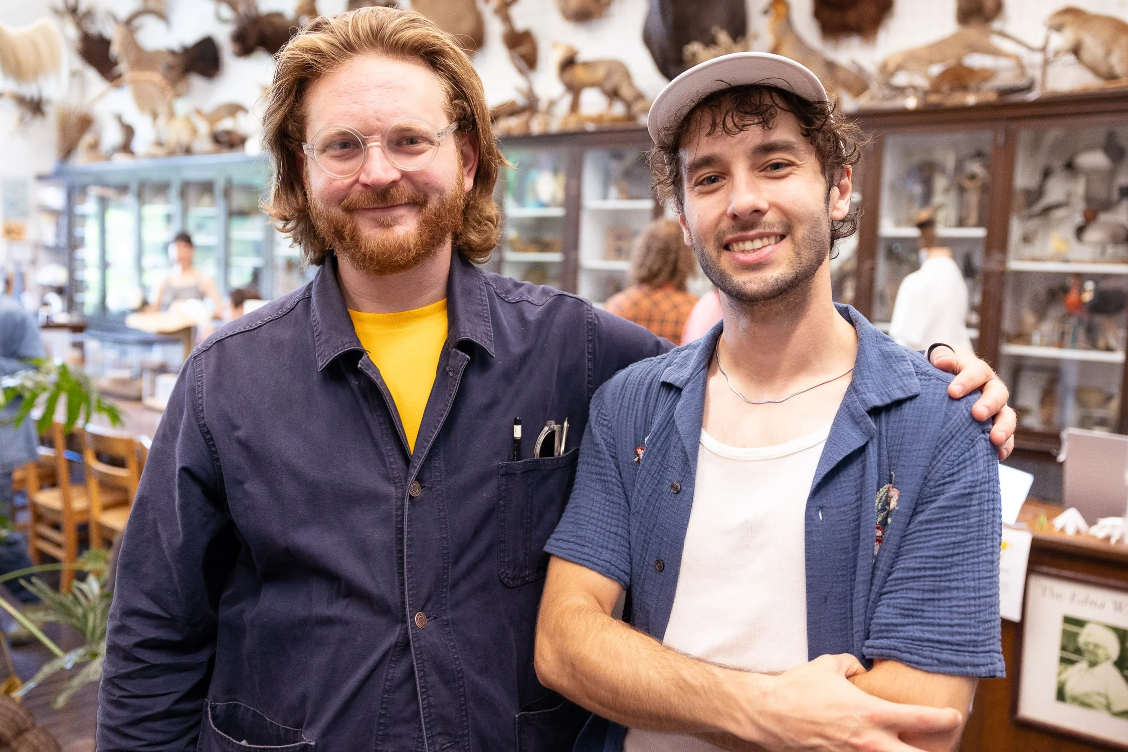Two smiling men standing in the nature lab at the Rhode Island School of Design summer reunion.
