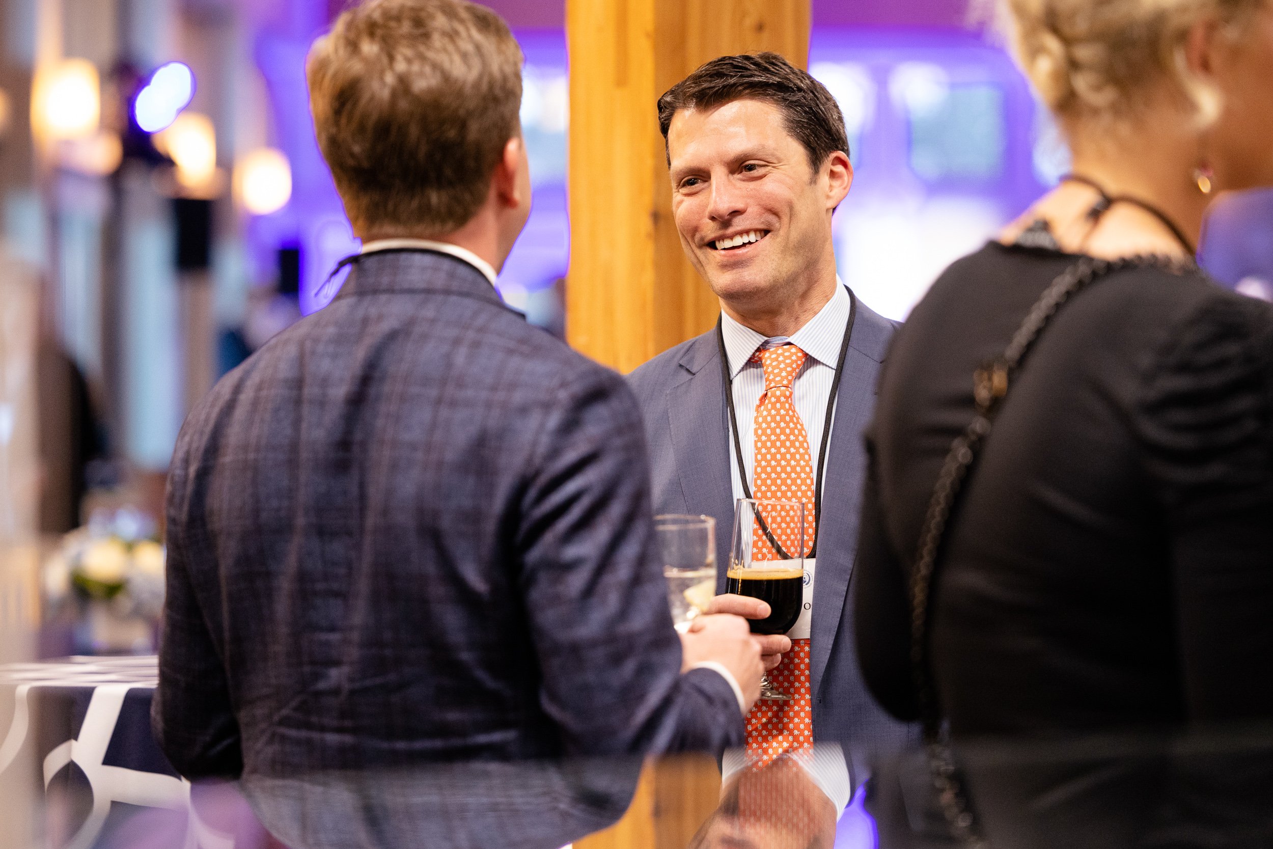People socializing at a networking event at a school in Massachusetts.