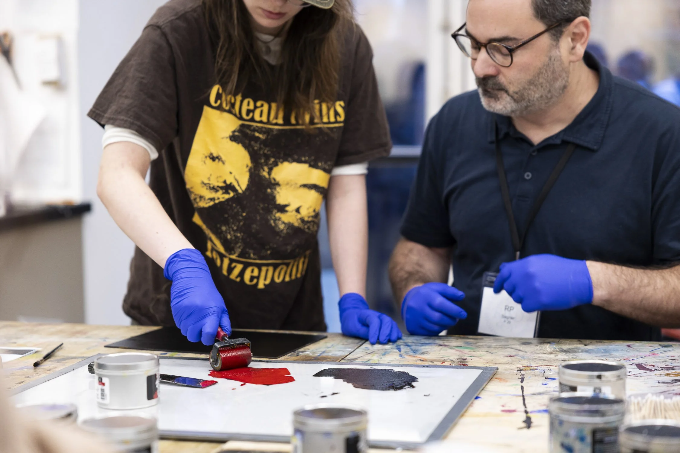 Two people working with printing inks at an art class in Boston.