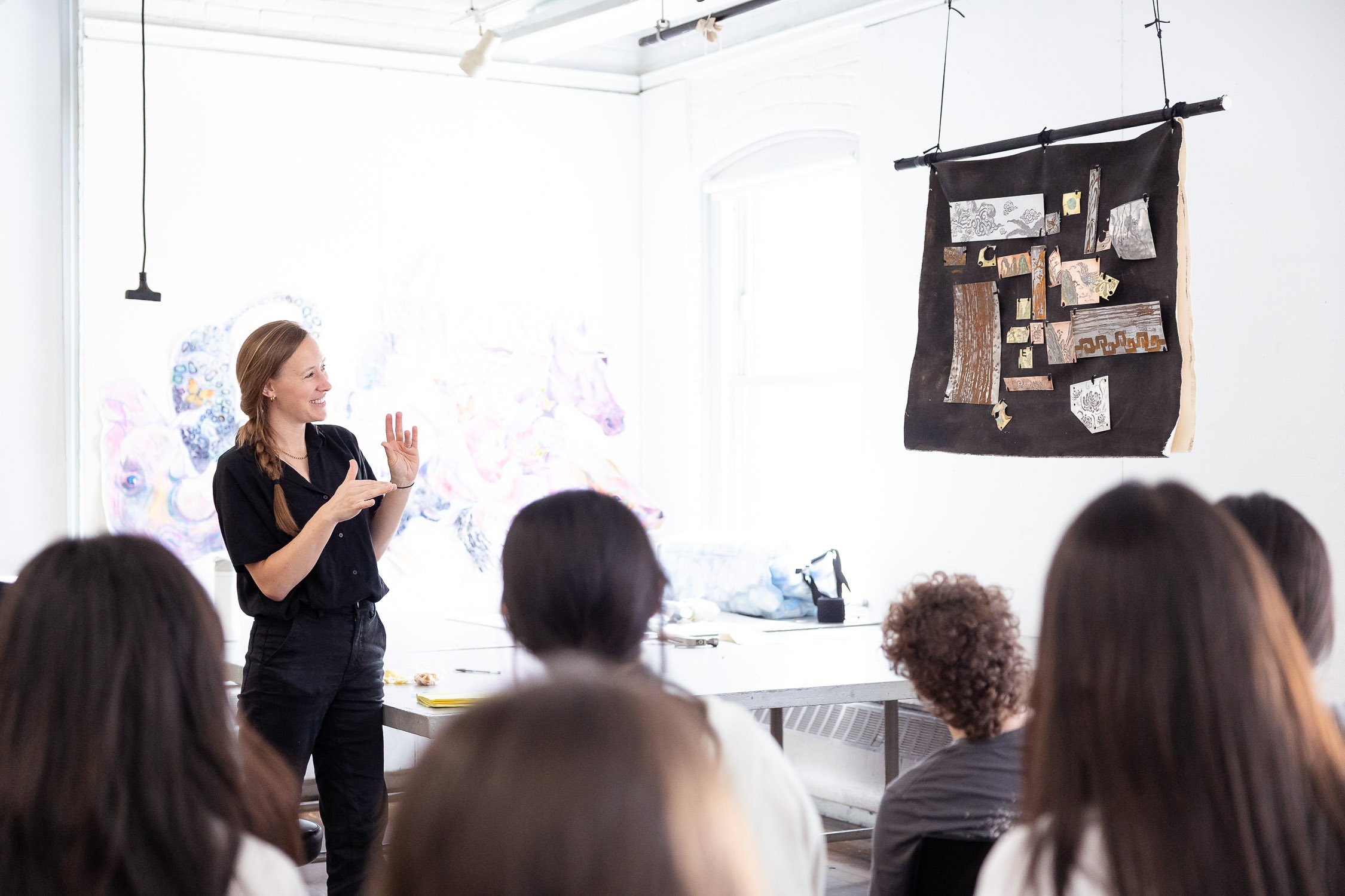 An instructor giving a presentation during an art critique at a Massachusetts art school.