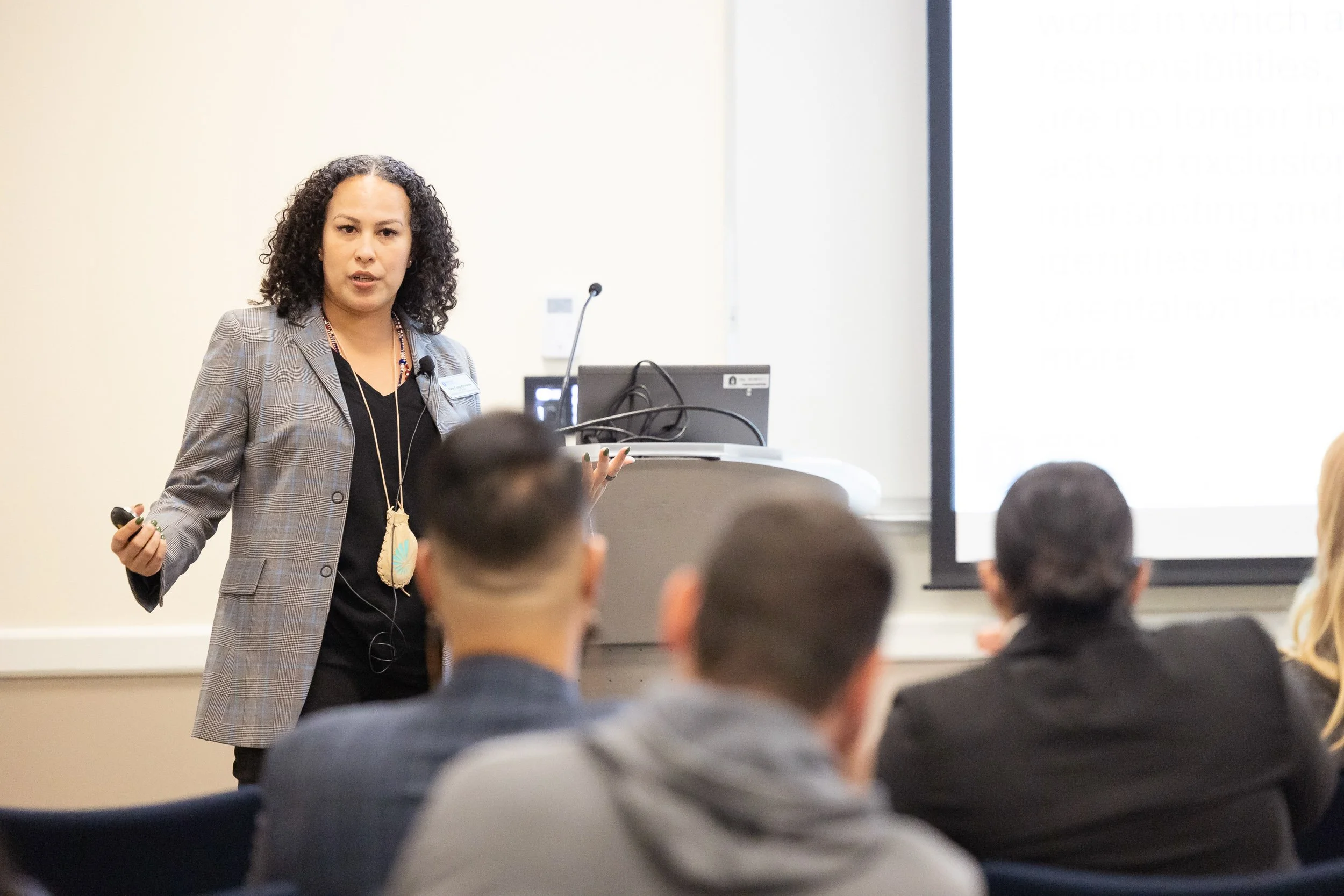 A woman giving a presentation at a Bentley University networking event.