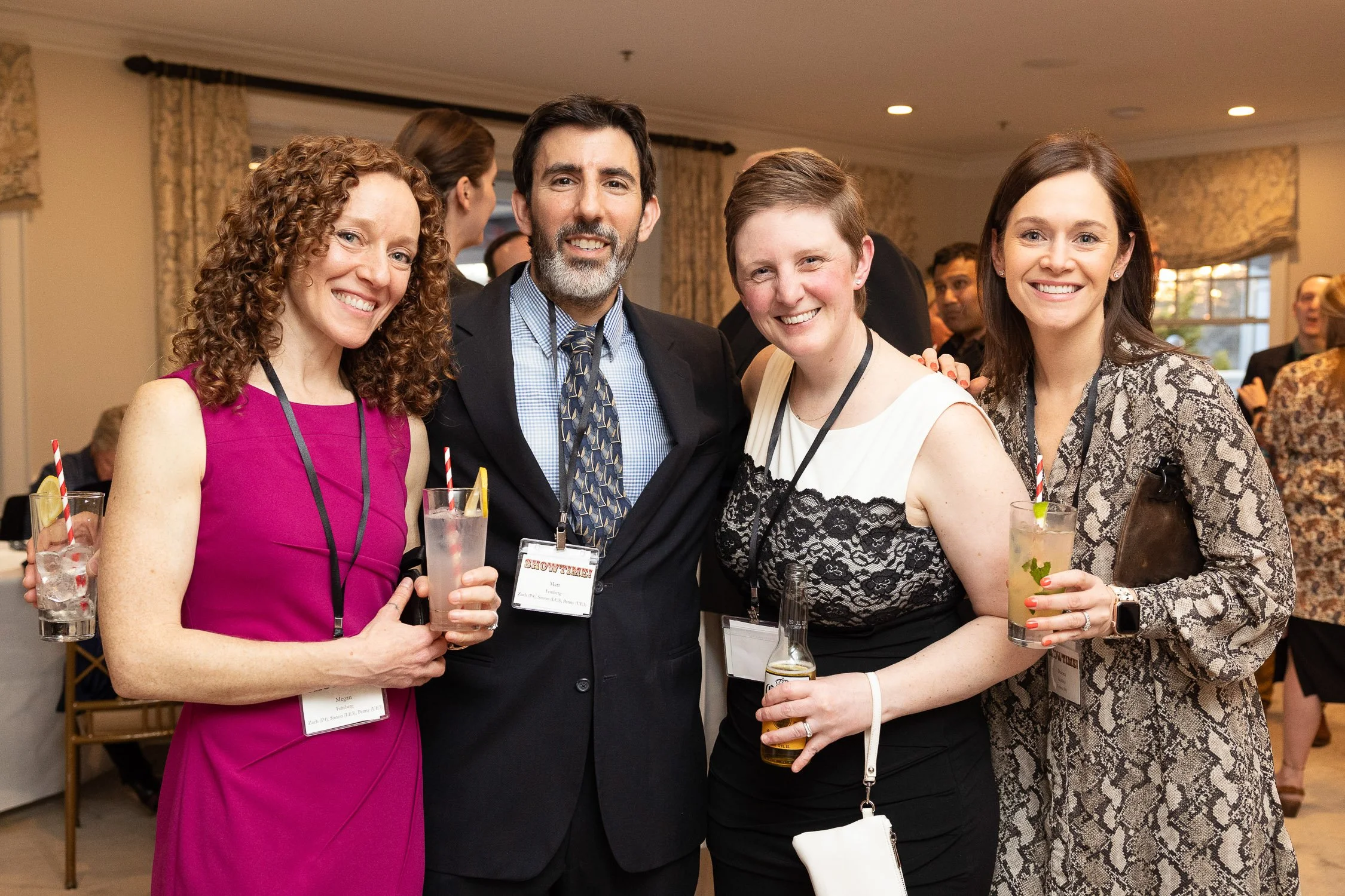 Group of four smiling people at an independent school fundraiser in Newton, Massachusetts.