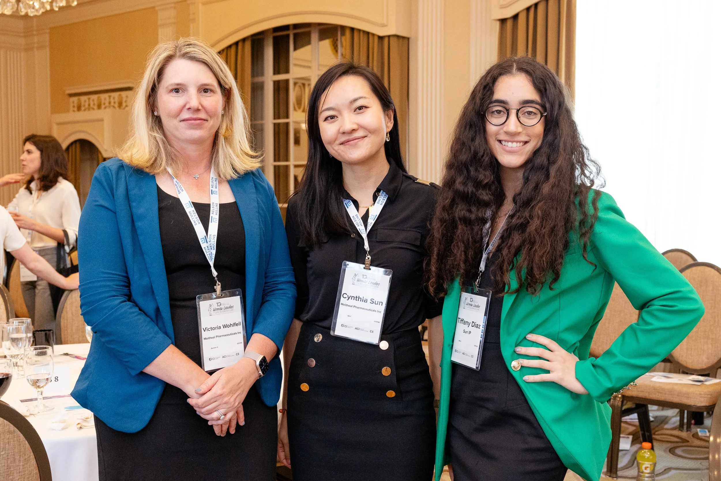 Three women standing together at a conference in Boston, Massachusetts.
