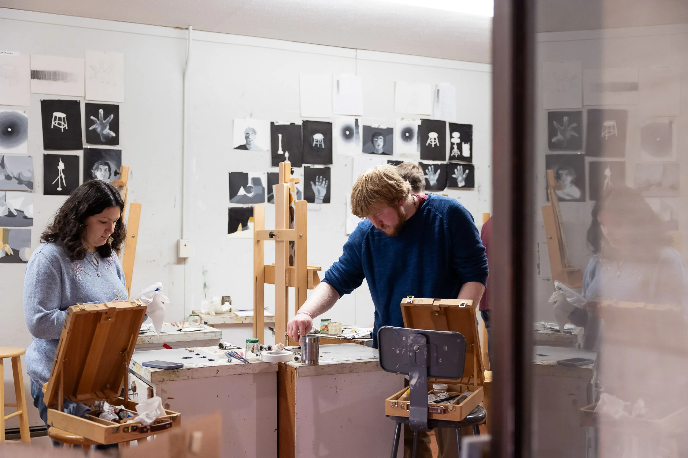Two students working in an art studio at Saint Anselm College.