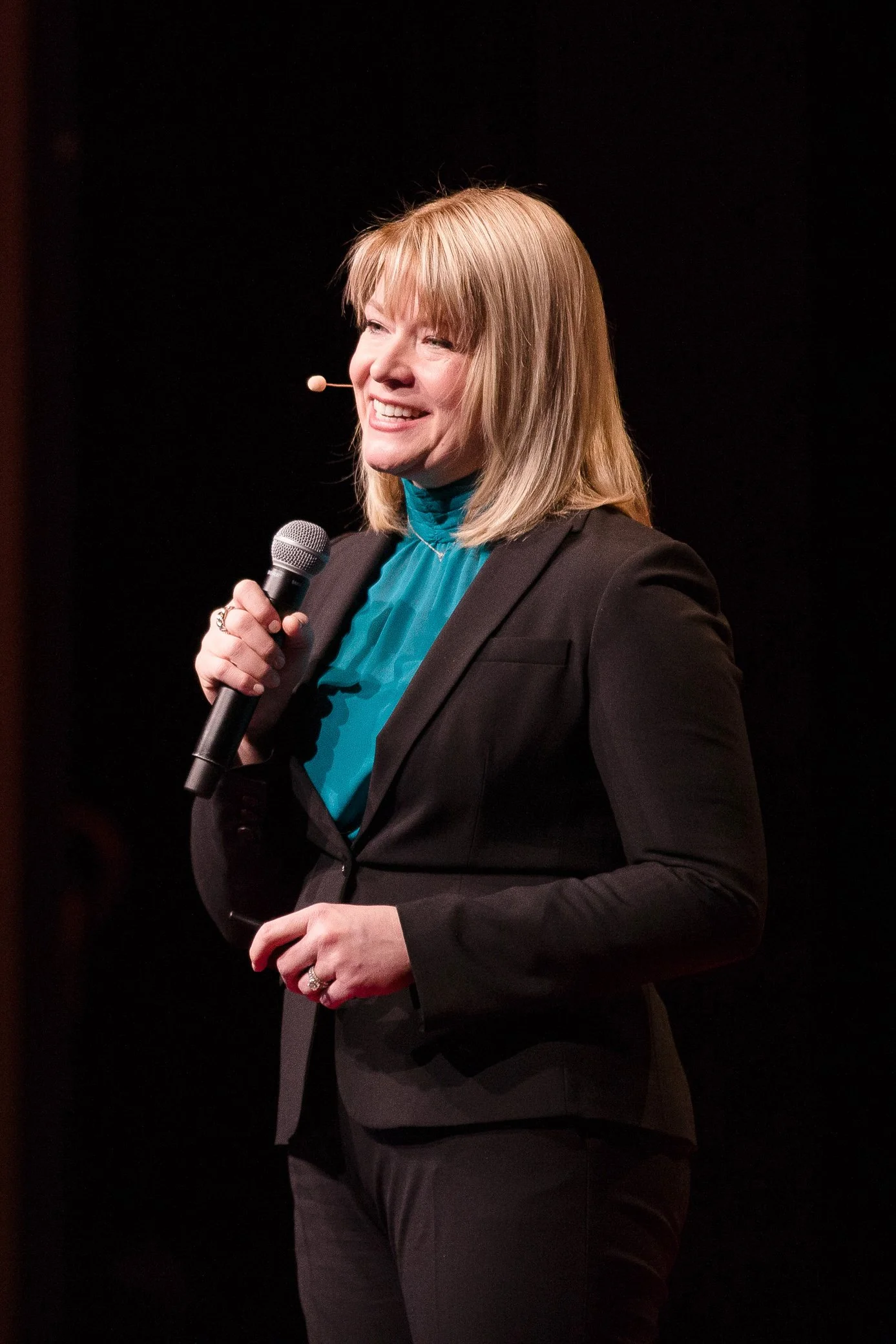A woman giving a TEDx talk in Natick, Massachusetts.