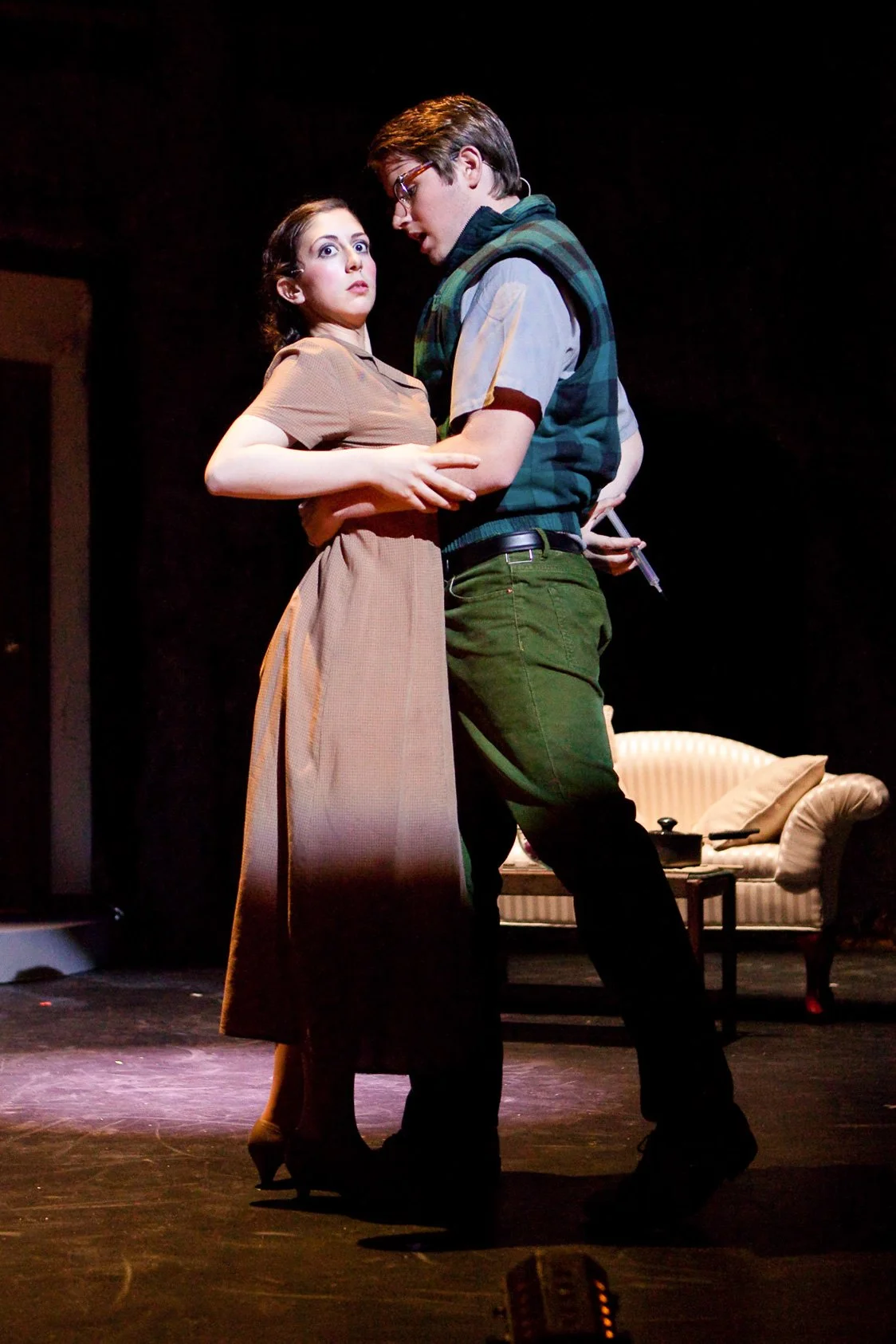 Two high school actors performing on stage in a high school production of Batboy musical.