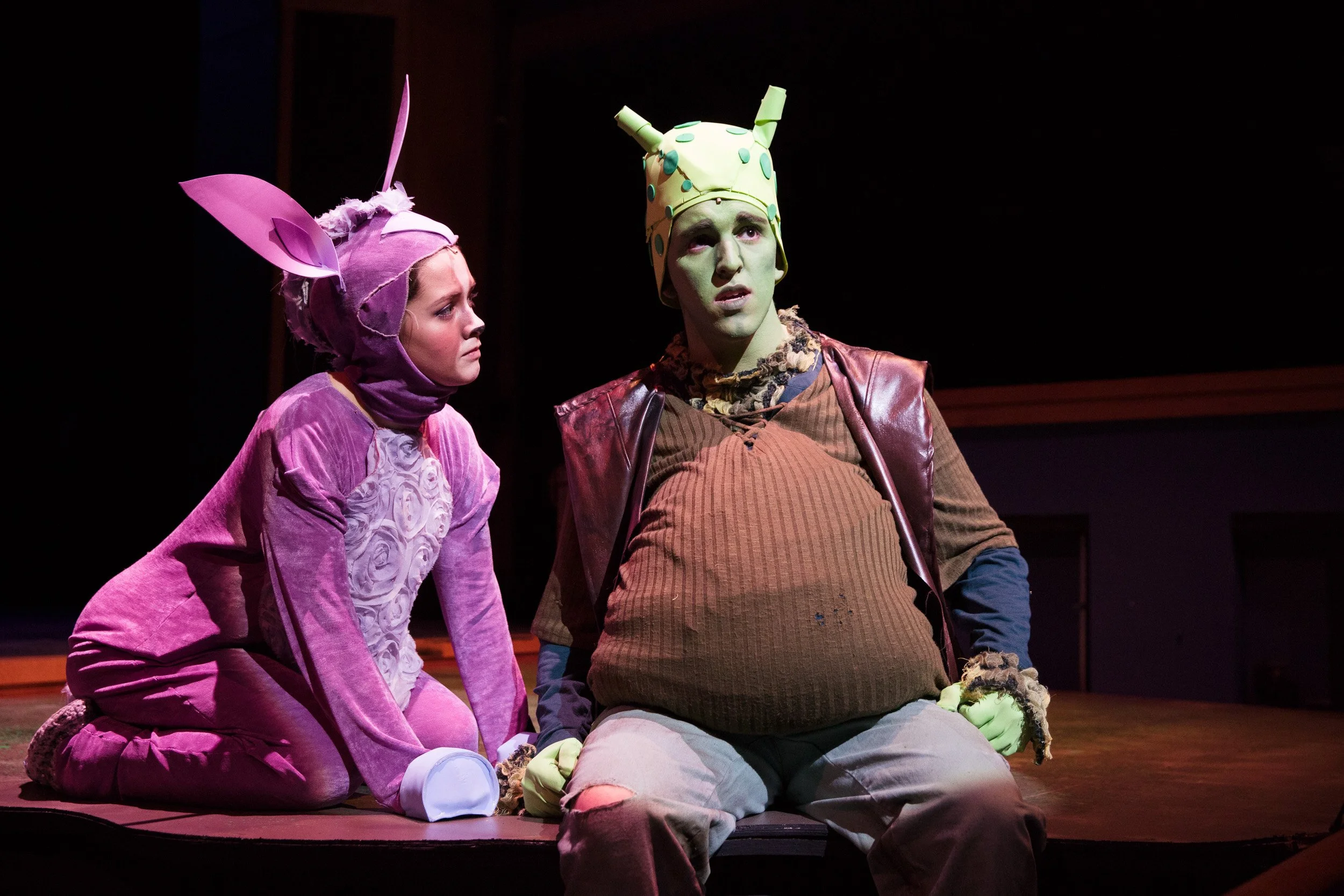 Two high school actors in colorful costumes perform in Shrek: the Musical at an independent school in Boston, Massachusetts.