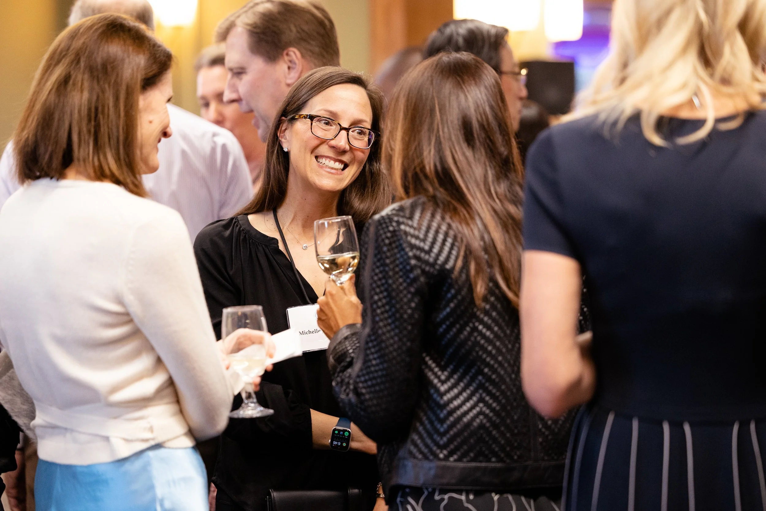 Group of people socializing at a fundraising event at an independent school in Massachuetts.
