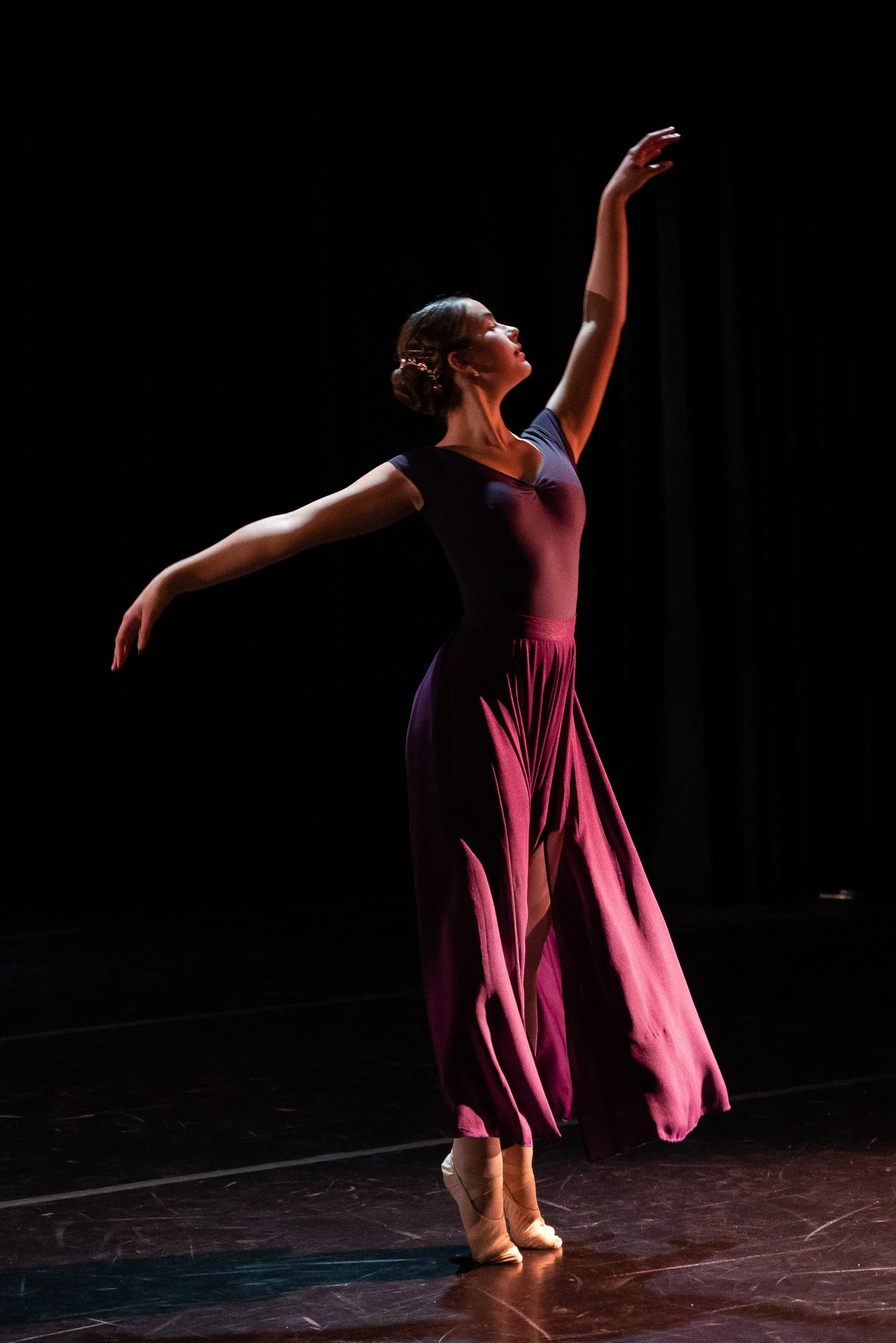 A ballet dancer performs on stage at a Massachusetts independent school dance recital.