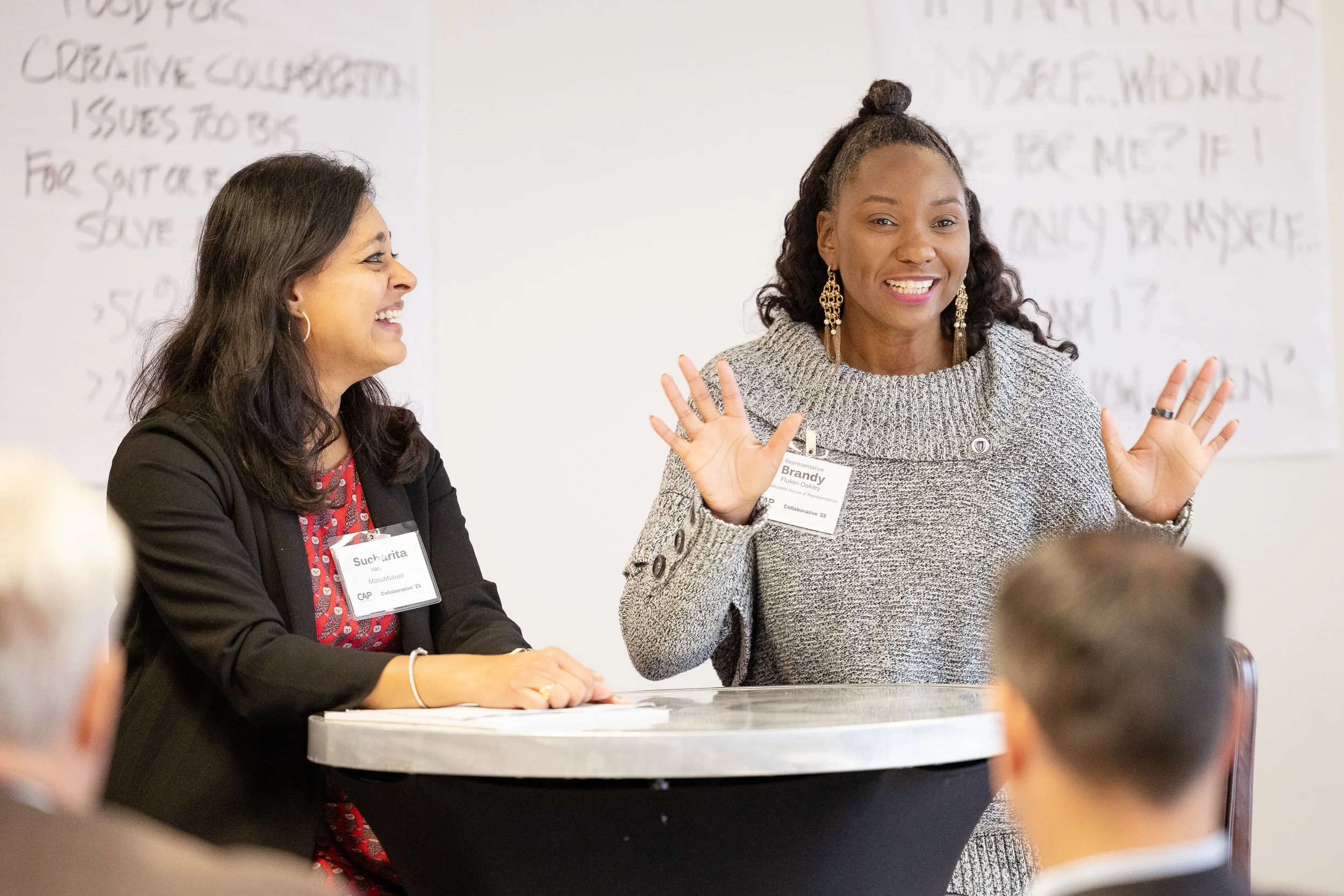 Two women speaking at a professional event for Civc Action Project in Boston.
