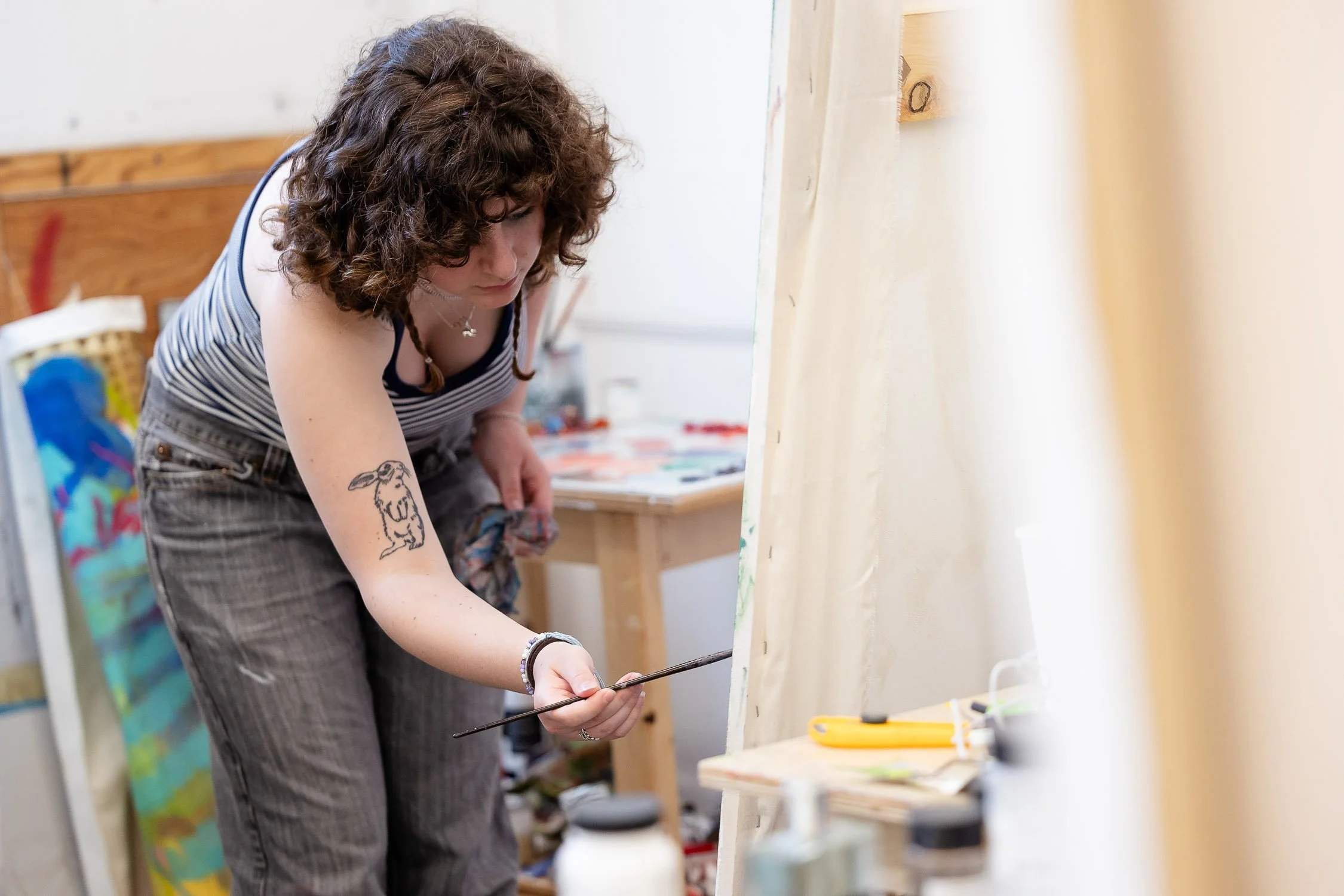 Young woman painting on a large canvas in an art studio at Rhode Island School of Design.