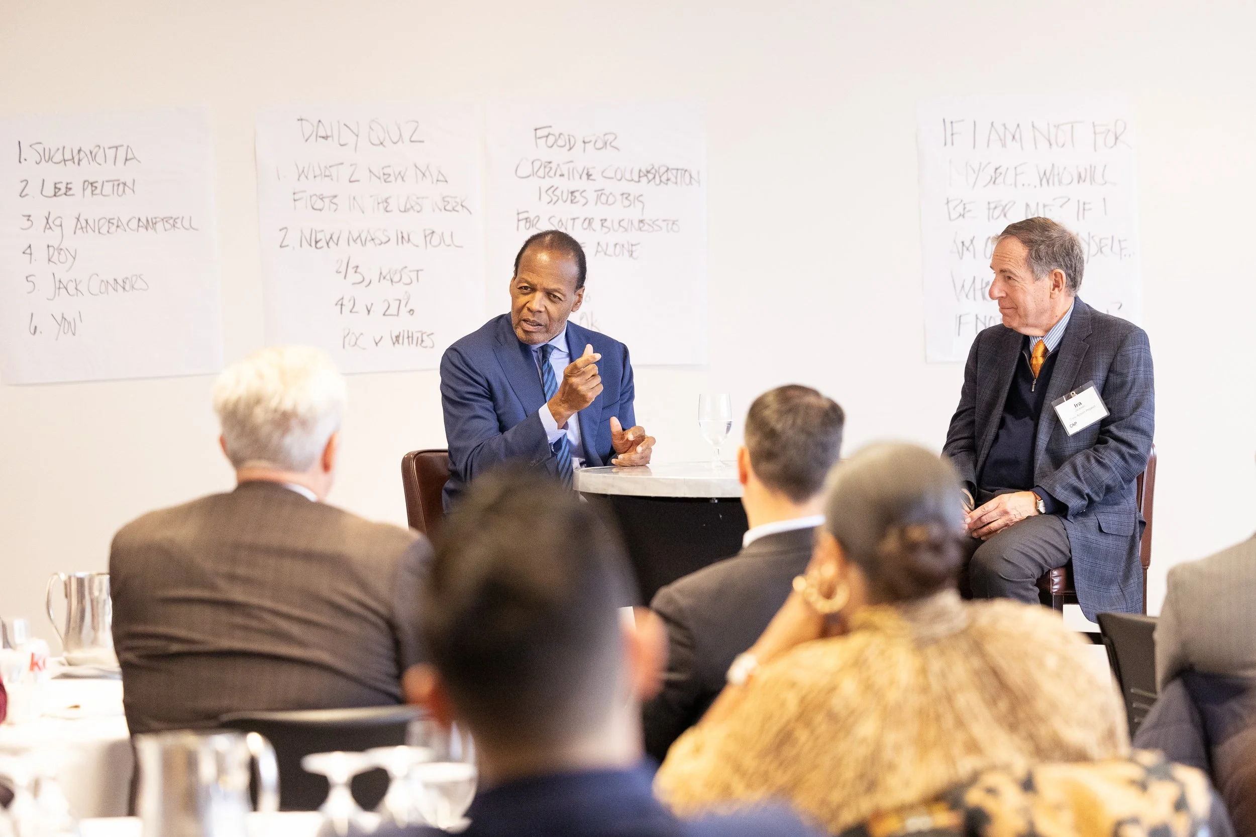 Lee Pelton sitting in front of audience at Civic Action Project meeting.