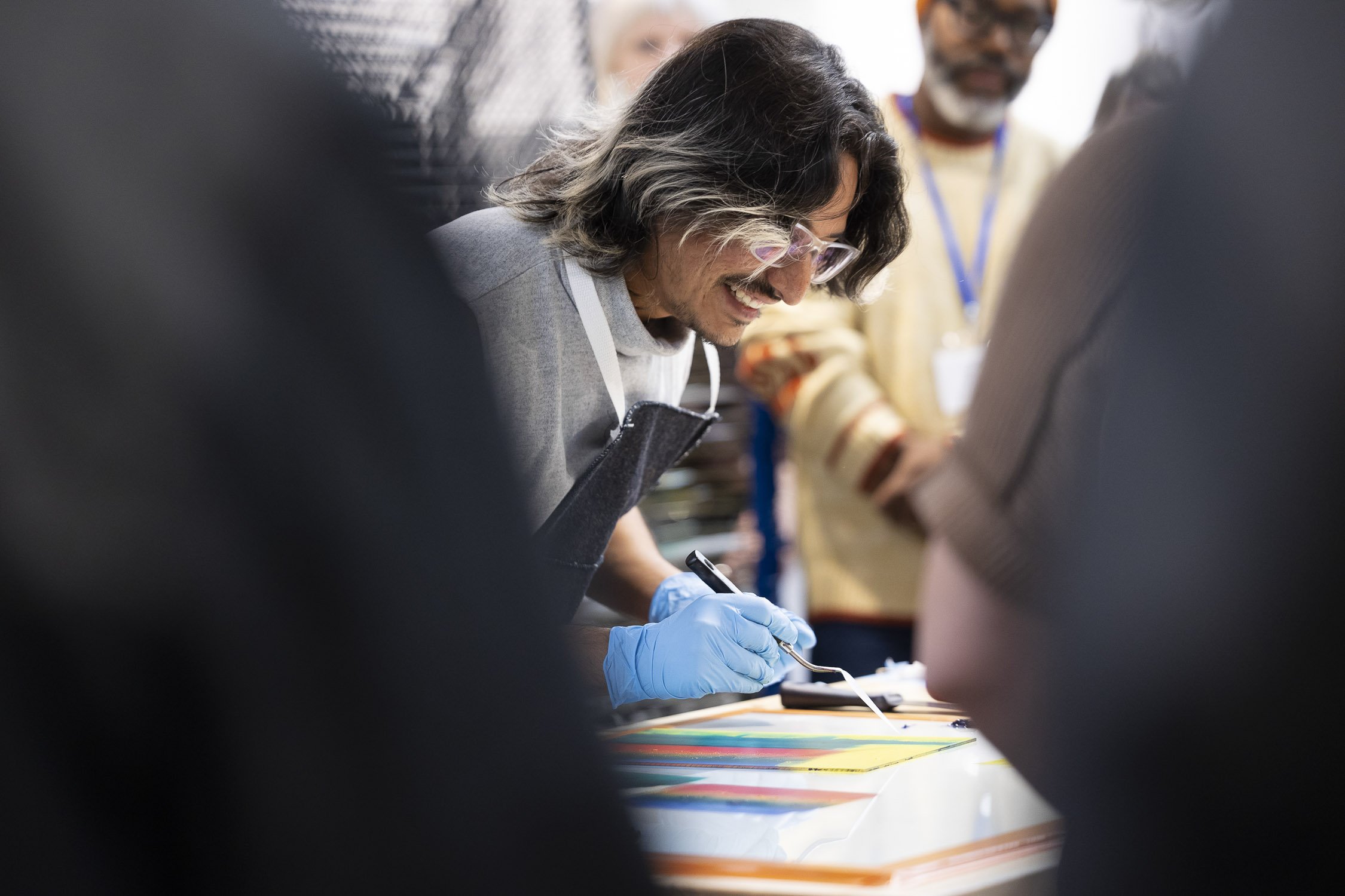 A man demonstrating printmaking at an art school workshop in Rhode Island.