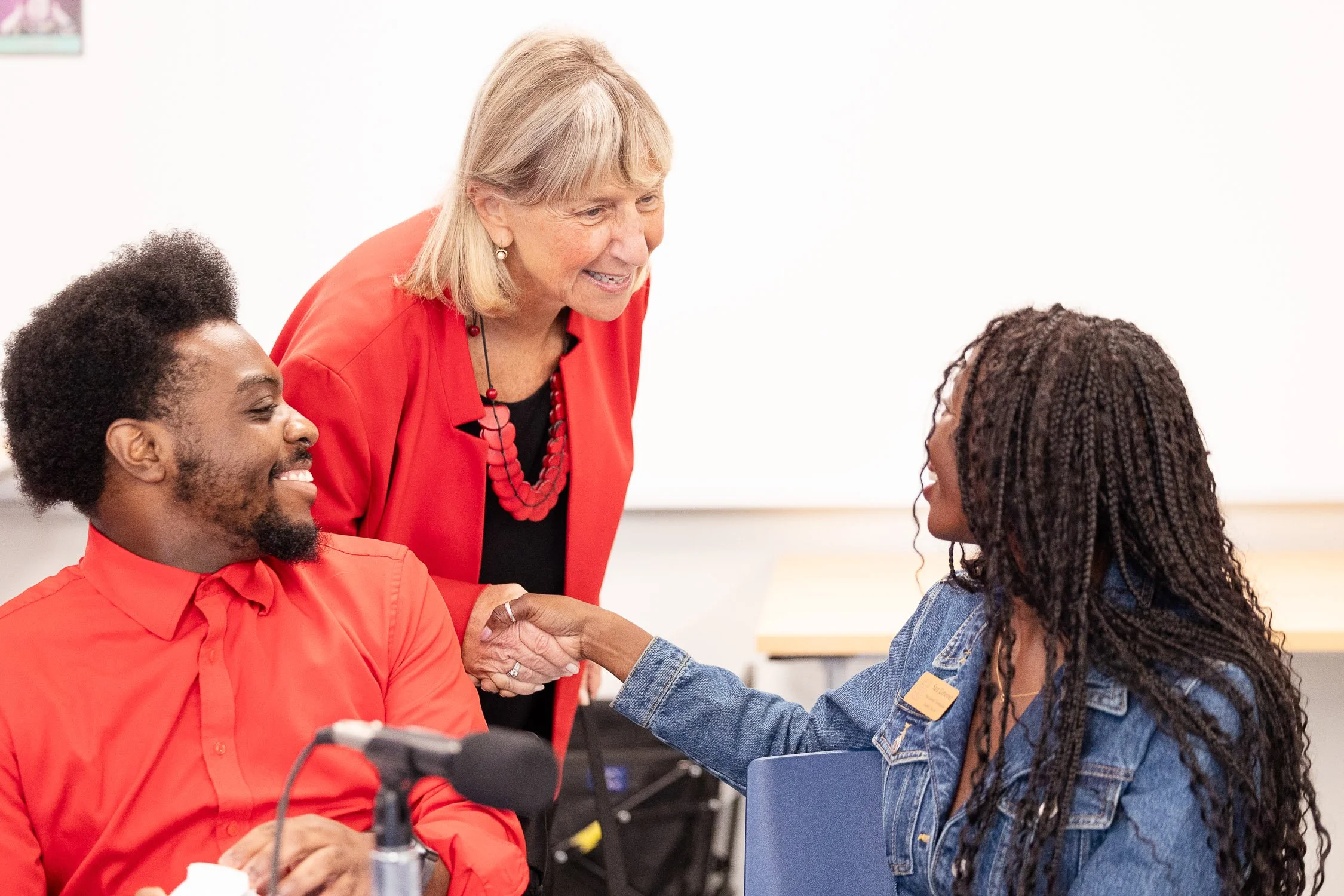 Karen Spilka shaking hands with MassBay Community College students.
