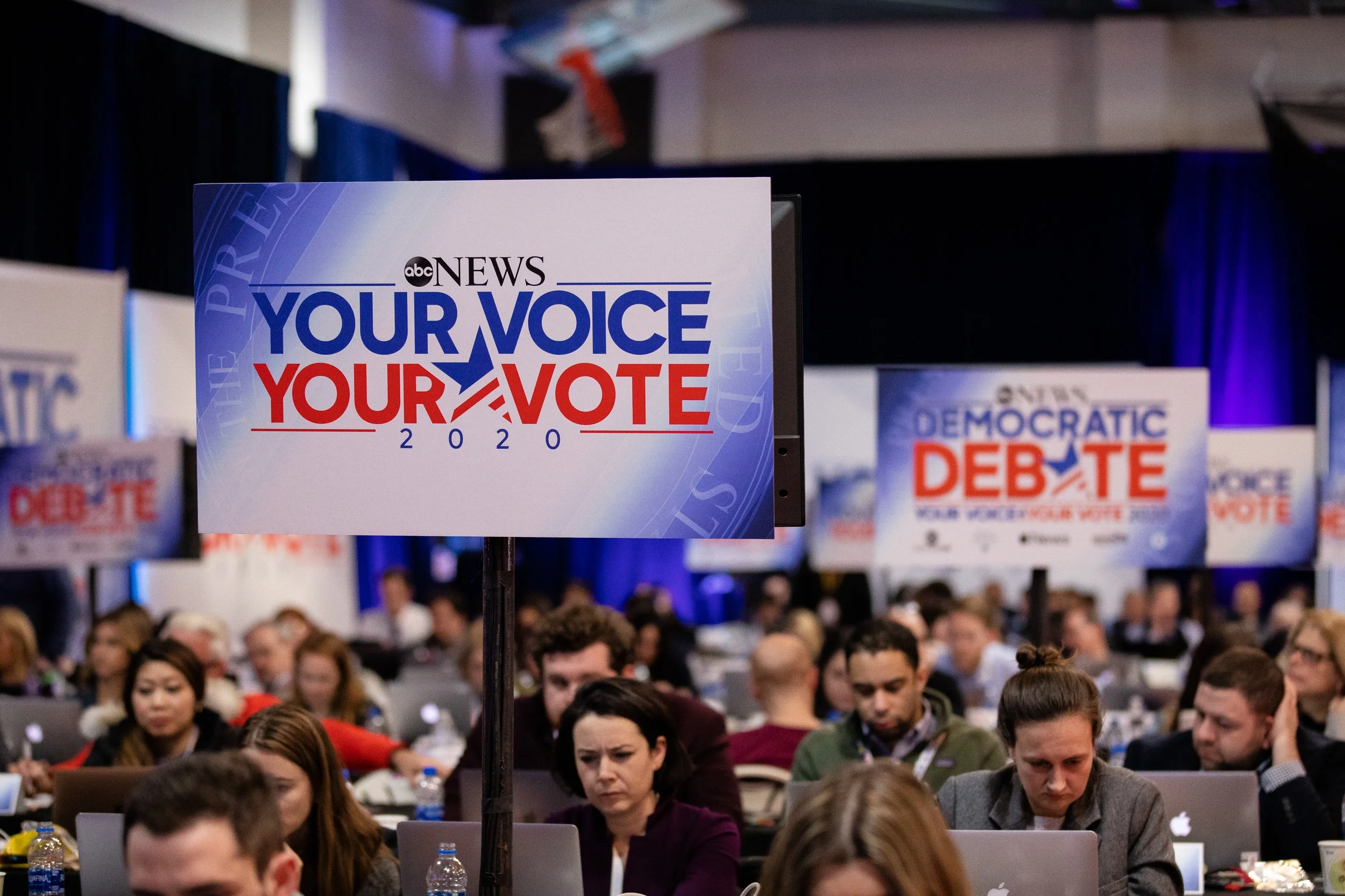 A large press room sign reads "Your Voice Your Vote 2020" with ABC News branding. 