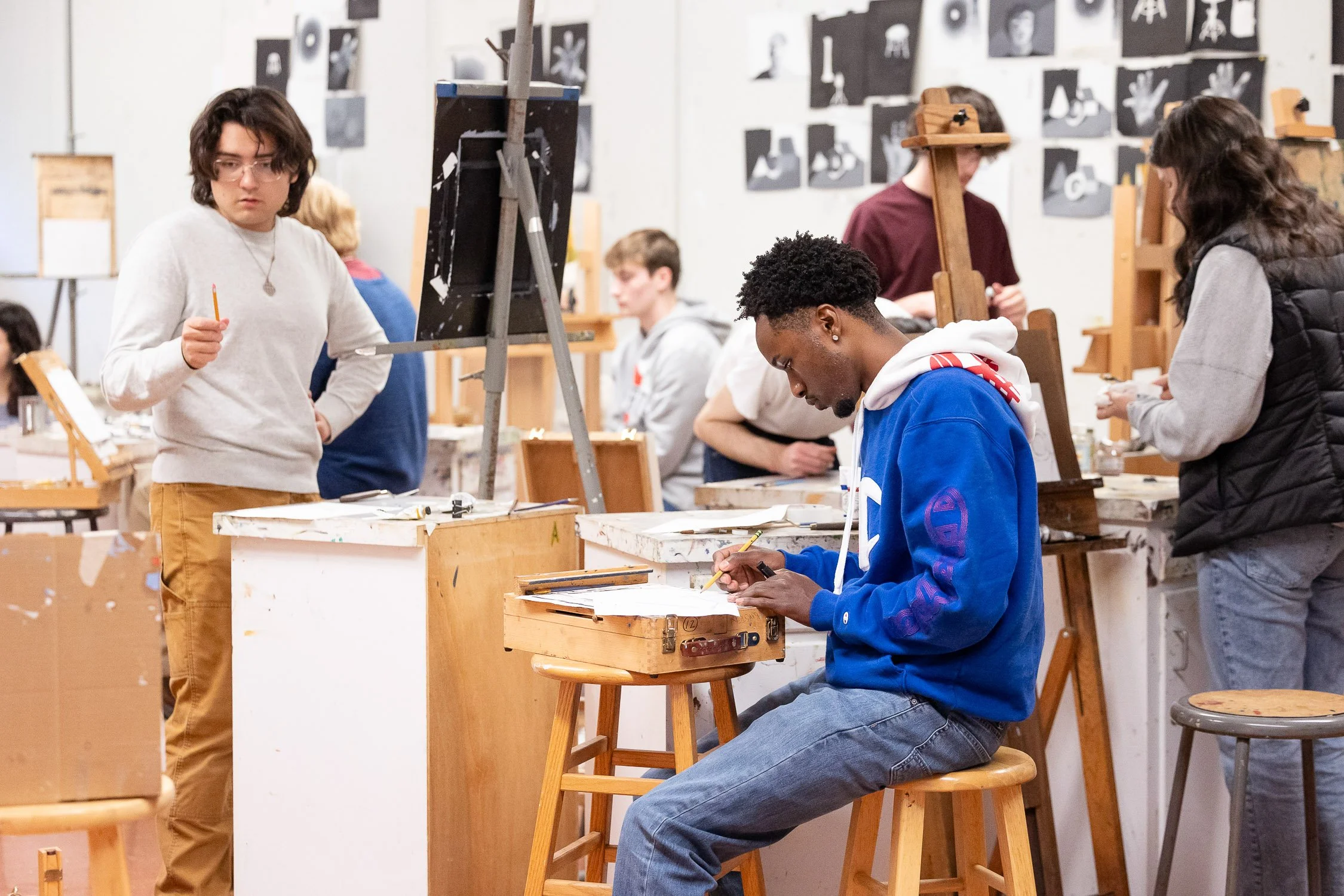Group of college students working on art projects in a studio at a Massachusetts university.